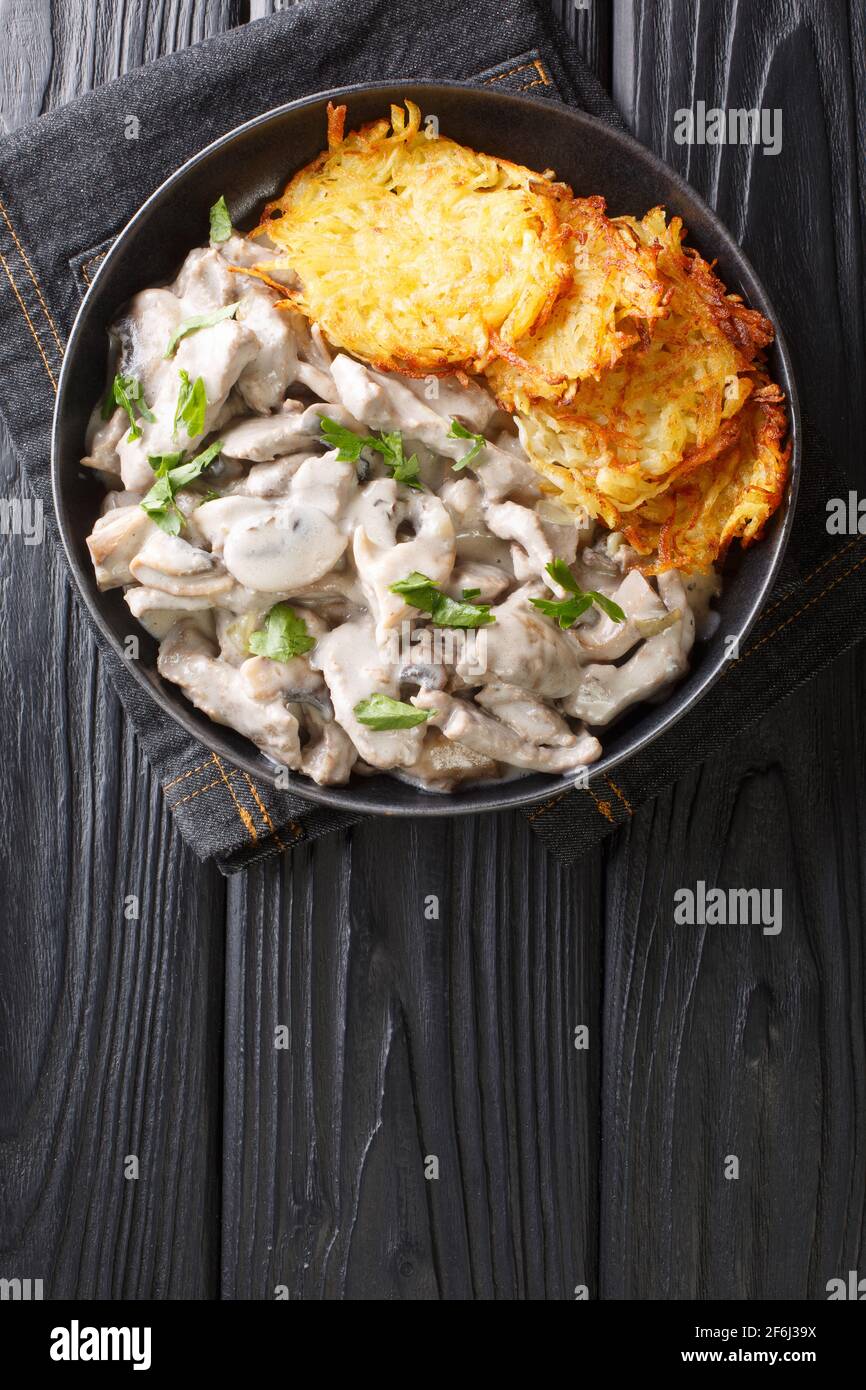 Zurich Ragout or Zurcher Geschnetzeltes Swiss simple ragout or stew recipe in a white sauce is made with mushrooms and white wine closeup in the plate Stock Photo