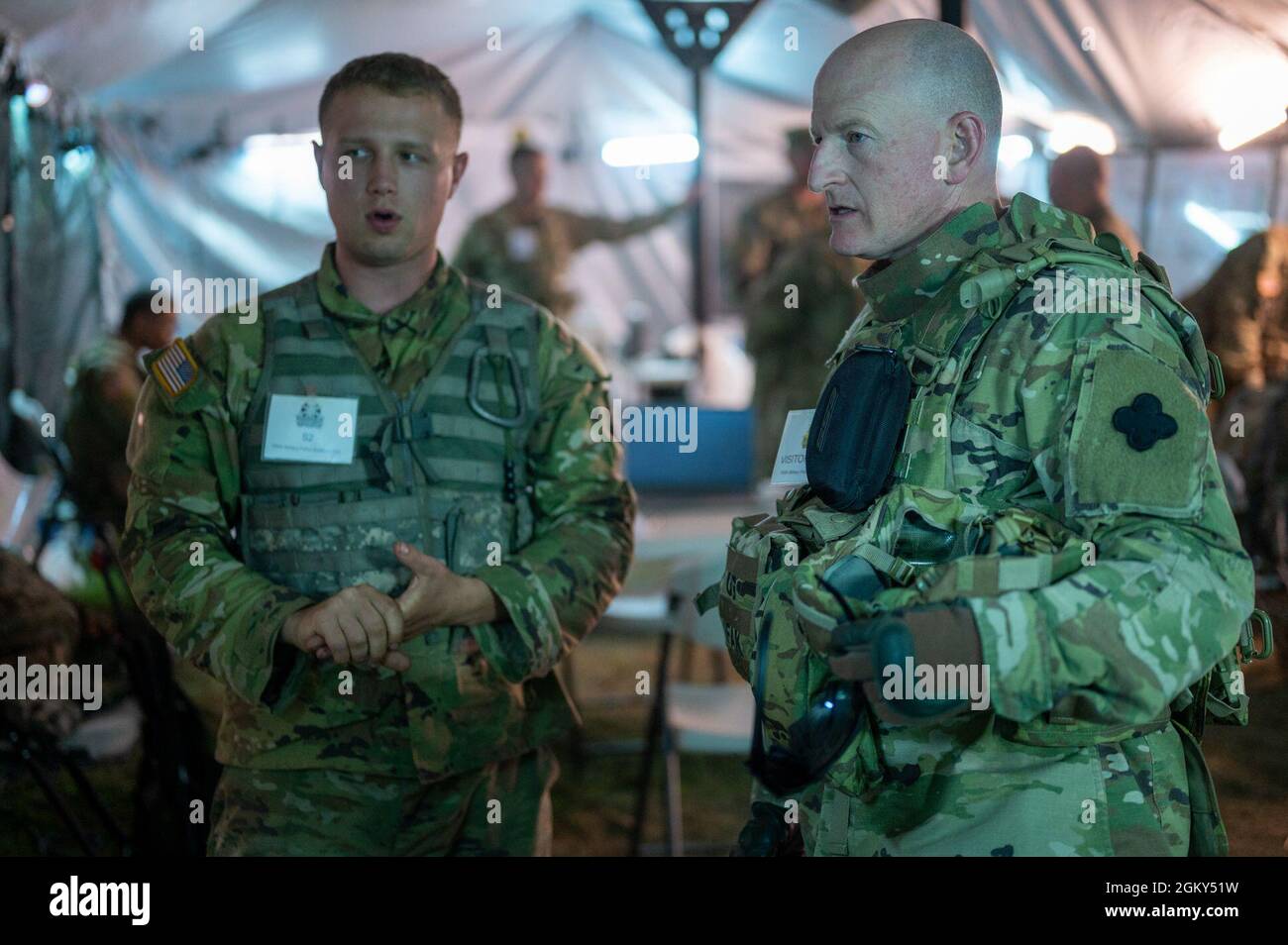 Brig. Gen. John Hafley, the deputy commanding general-operations for the 88th Readiness Division, right, receives a notional intelligence brief from 1st Lt. Adam Johnston, a military intelligence officer of the 785th Military Police Battalion, 200th Military Police Command, left, as part of Pershing Strike 21 July 25, 2021, on Fort McCoy, Wis. Pershing Strike 21 is a training exercise for six Army Reserve units. Stock Photo