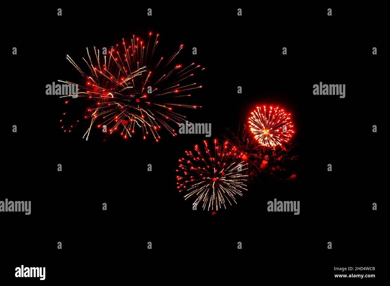 Red fireworks on a black background. Festive Christmas lighting element for decoration. Sparks. Fireworks Are A Class Of Explosive Pyrotechnic Devices Stock Photo