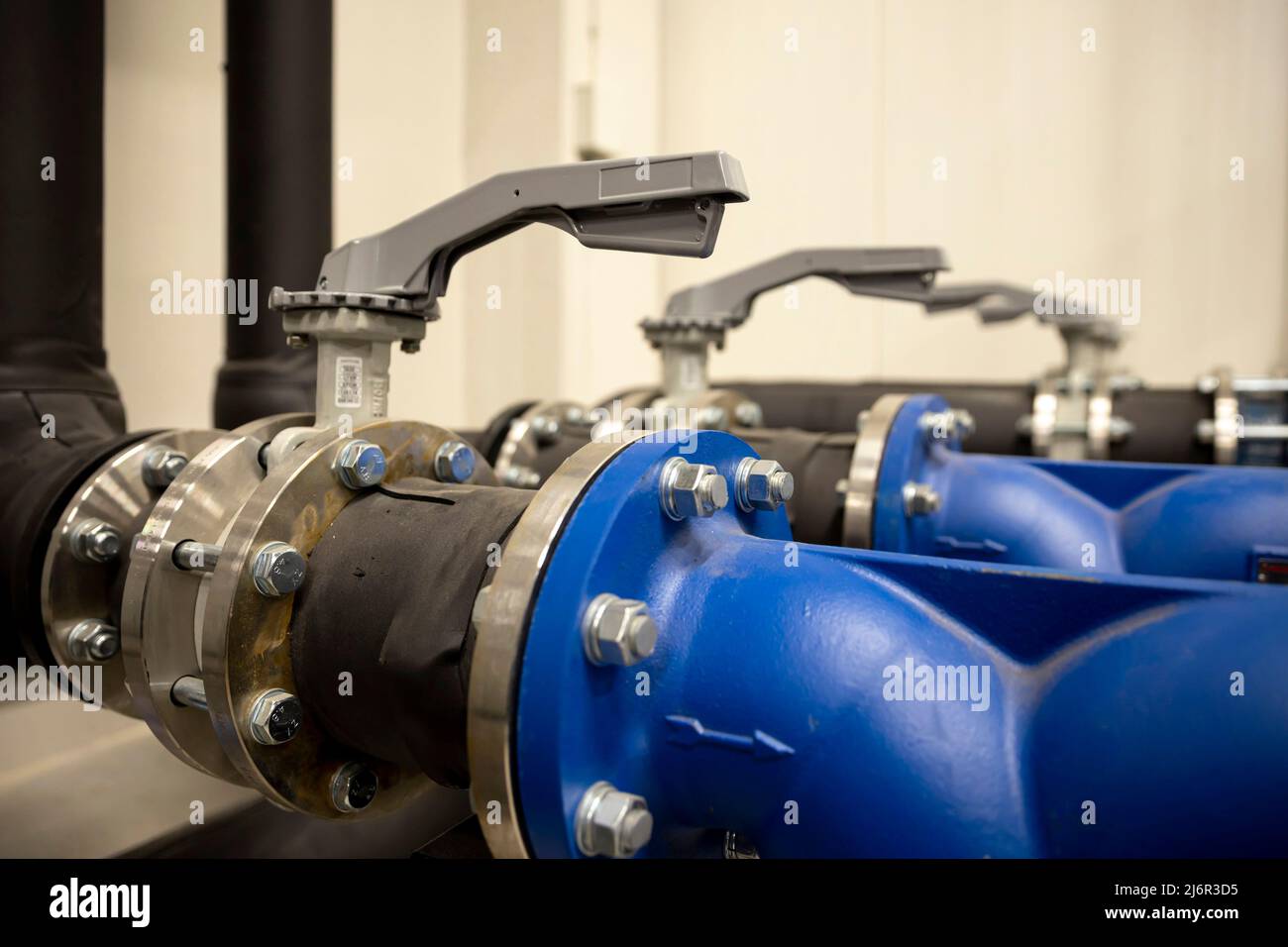 Cooling system of a supercomputer. Metal pipes with valves. Stock Photo