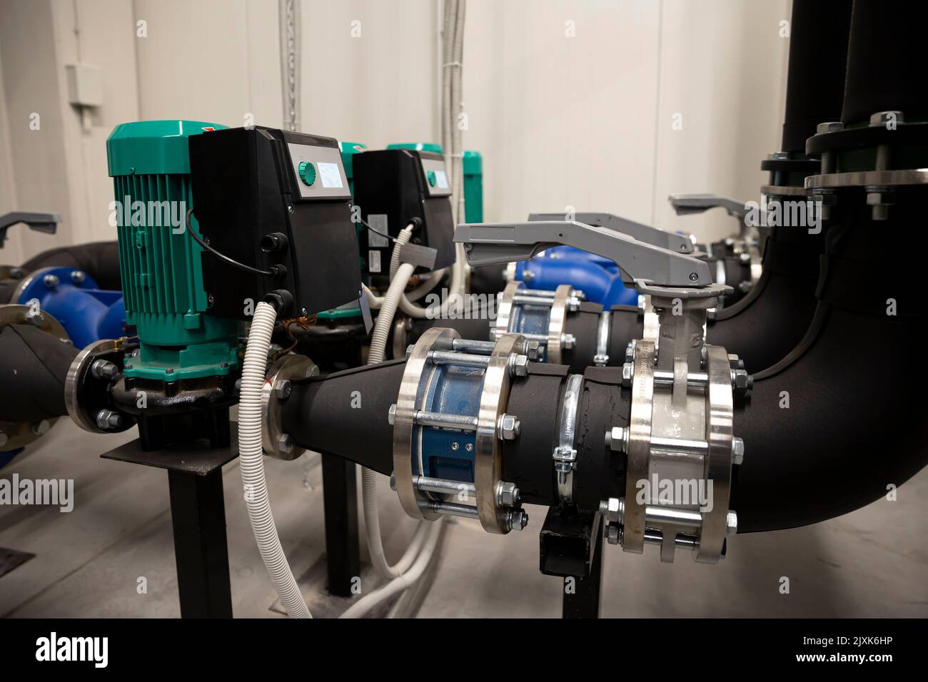 Cooling system of a supercomputer. Pipes with electrical motors. Stock Photo