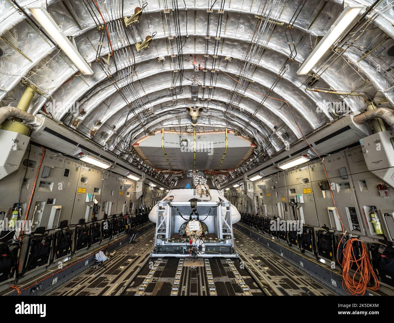 The Orion team prepares the parachute test vehicle for the final drop test which will qualify Orion's parachutes for human flight on Sept. 10, 2018...On September 12, 2018 an Orion test capsule will be dropped from a C-17 aircraft at an altitude of more than six miles to verify the spacecraft’s complex system of 11 parachutes, cannon-like mortars, and pyrotechnic devices work in sequence to slow the capsule’s descent for a safe landing on Earth. Stock Photo