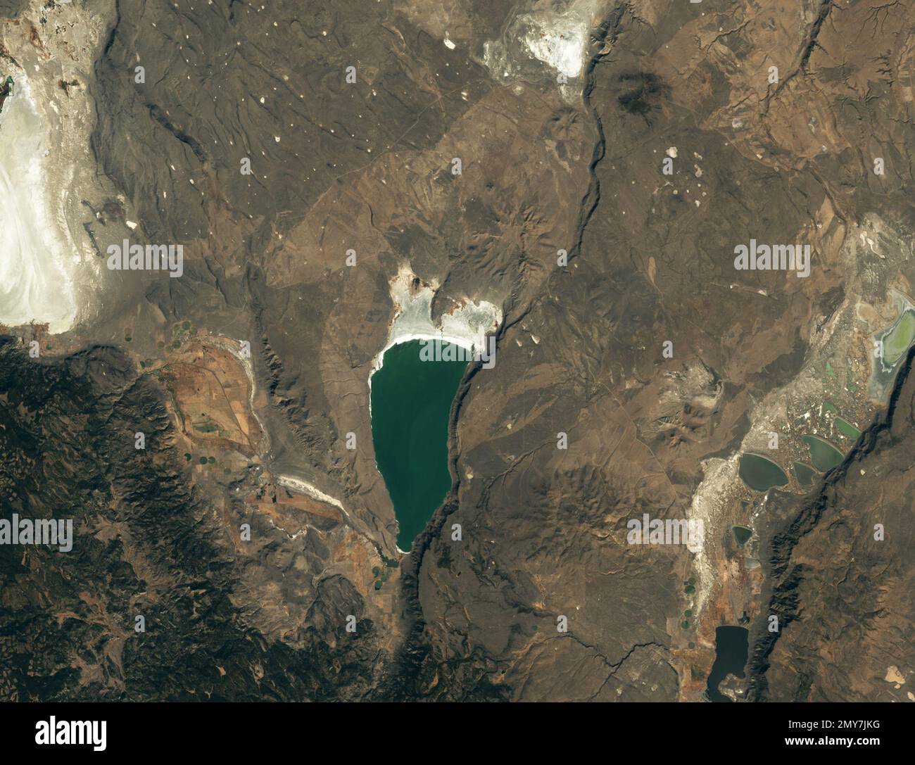 Lake Abert, Oregon, USA. 27th Jan, 2023. A Landsat 7 image shows lake in October 2002, when water levels were at nearly the highest levels they have been during the past two decades. Every year, tens of thousands of birds flock to Lake Abert as they journey from parts of the Great Basin toward the Pacific flyway, a migration route that extends from Alaska to South America. The shallow, salty lake in southern Oregon has long functioned like an all-you-can-eat buffet for many of these winged travelers with large quantities of alkali flies and tiny crustaceans called brine shrimp.The lake mos Stock Photo