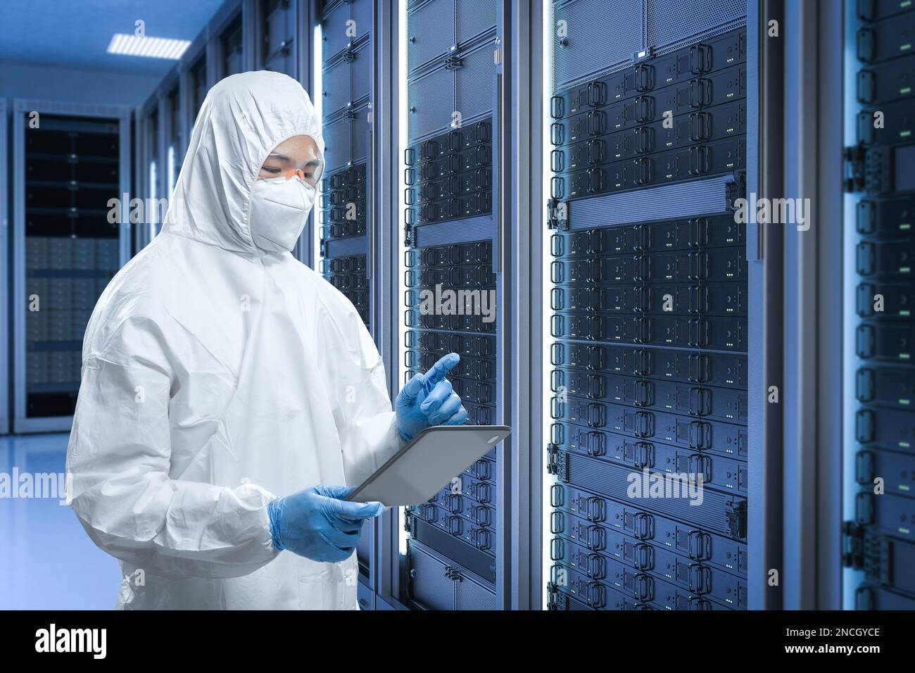 Programmer or engineer with computer notebook in server room Stock Photo