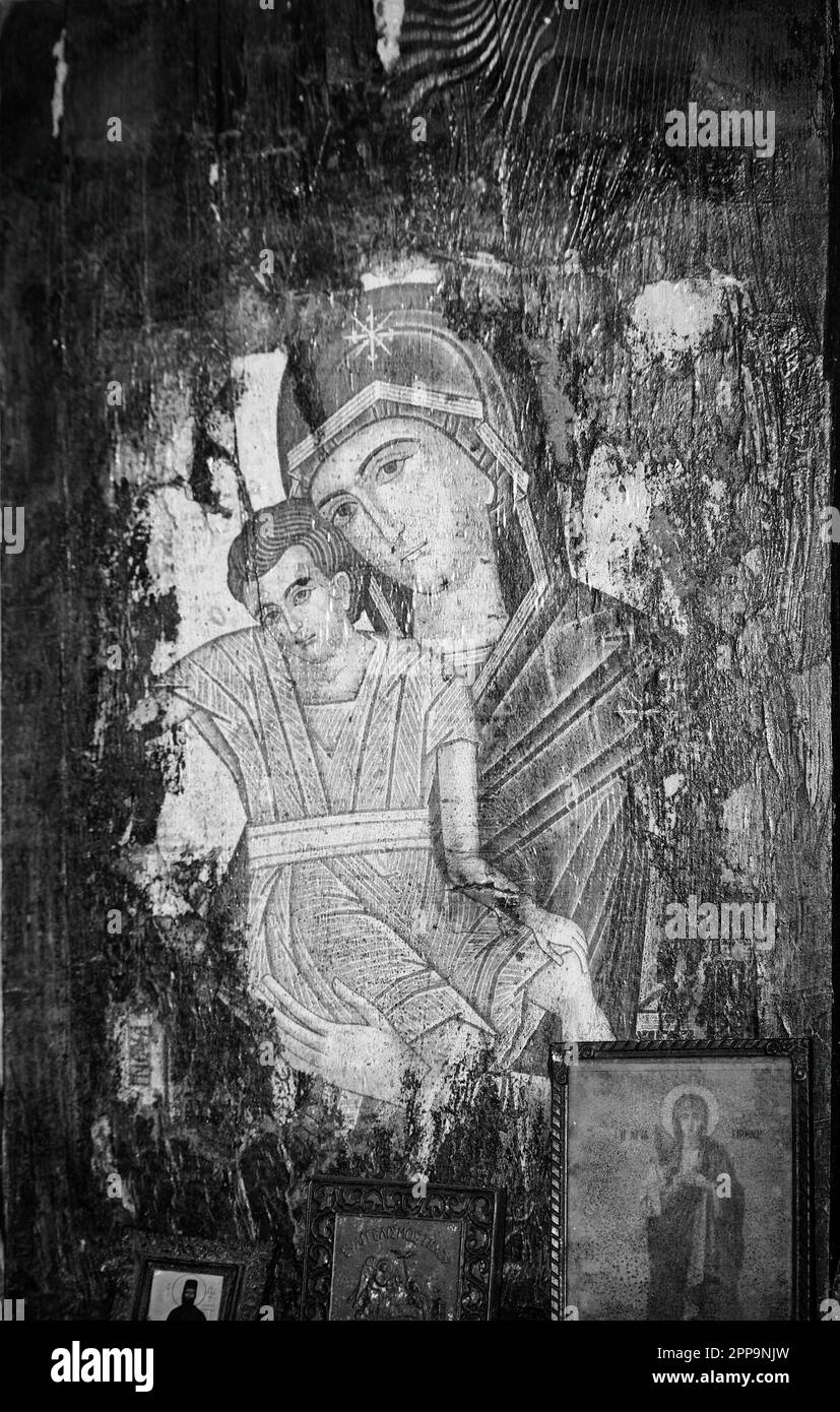 Athens, Greece - March 26, 2023: A monochromatic religious icon of the Virgin Mary carrying the baby Jesus inside the cave church at Penteli Mountain, Stock Photo