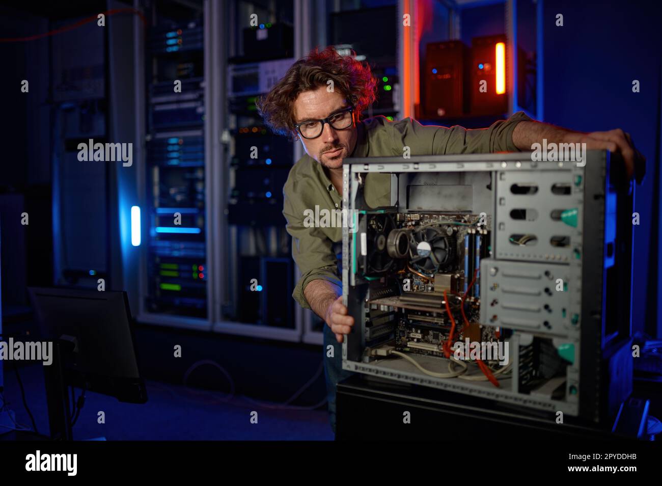 Repairman working with computer system unit at PC repair service center Stock Photo