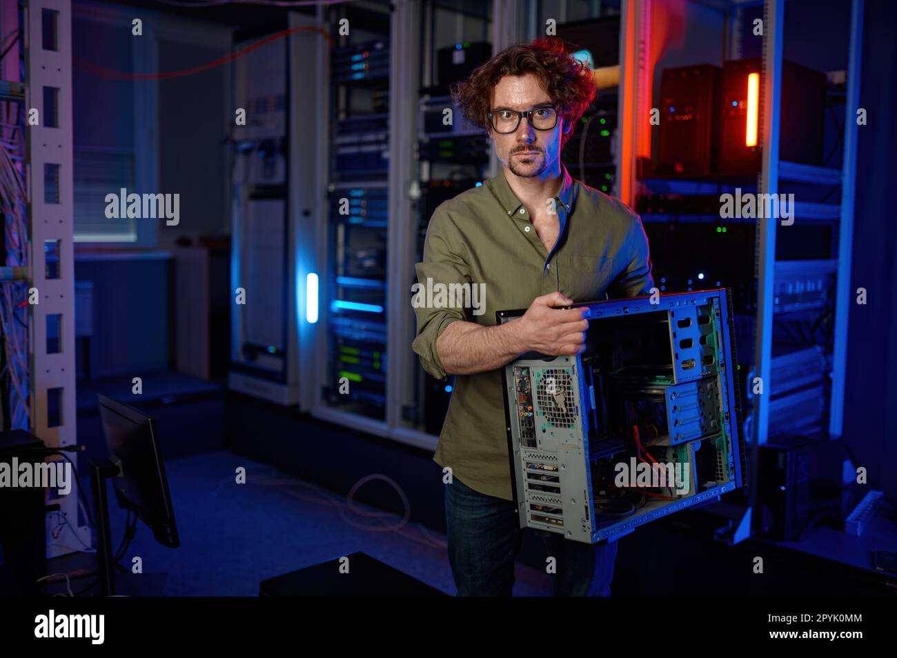 Repairman working with computer system unit at PC repair service center Stock Photo