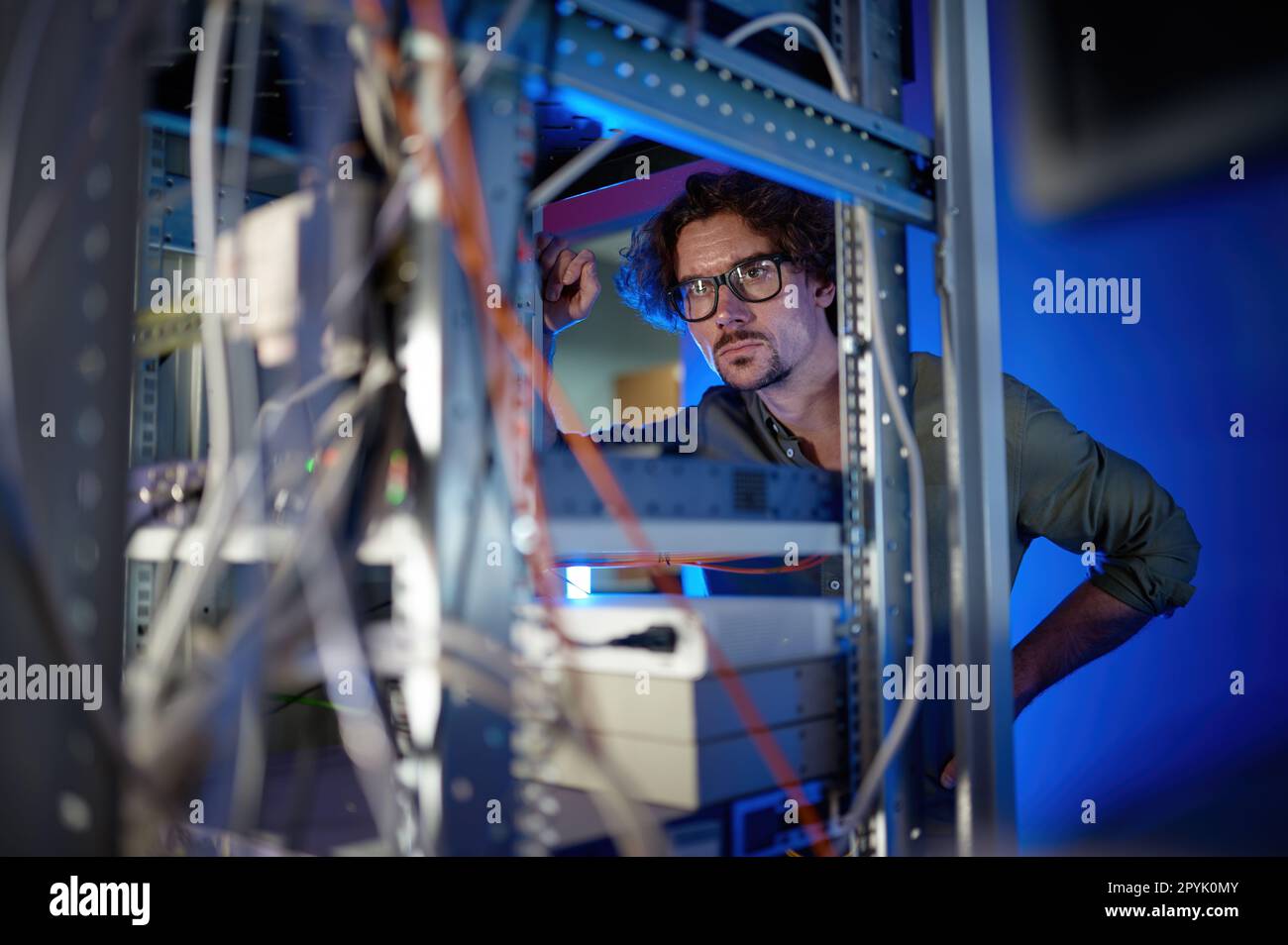 Man technician repairing supercomputer system unit, changing parts Stock Photo