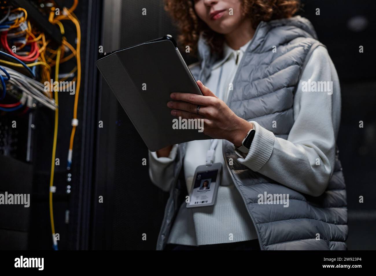 IT professional using tablet PC and setting supercomputer system in database room Stock Photo