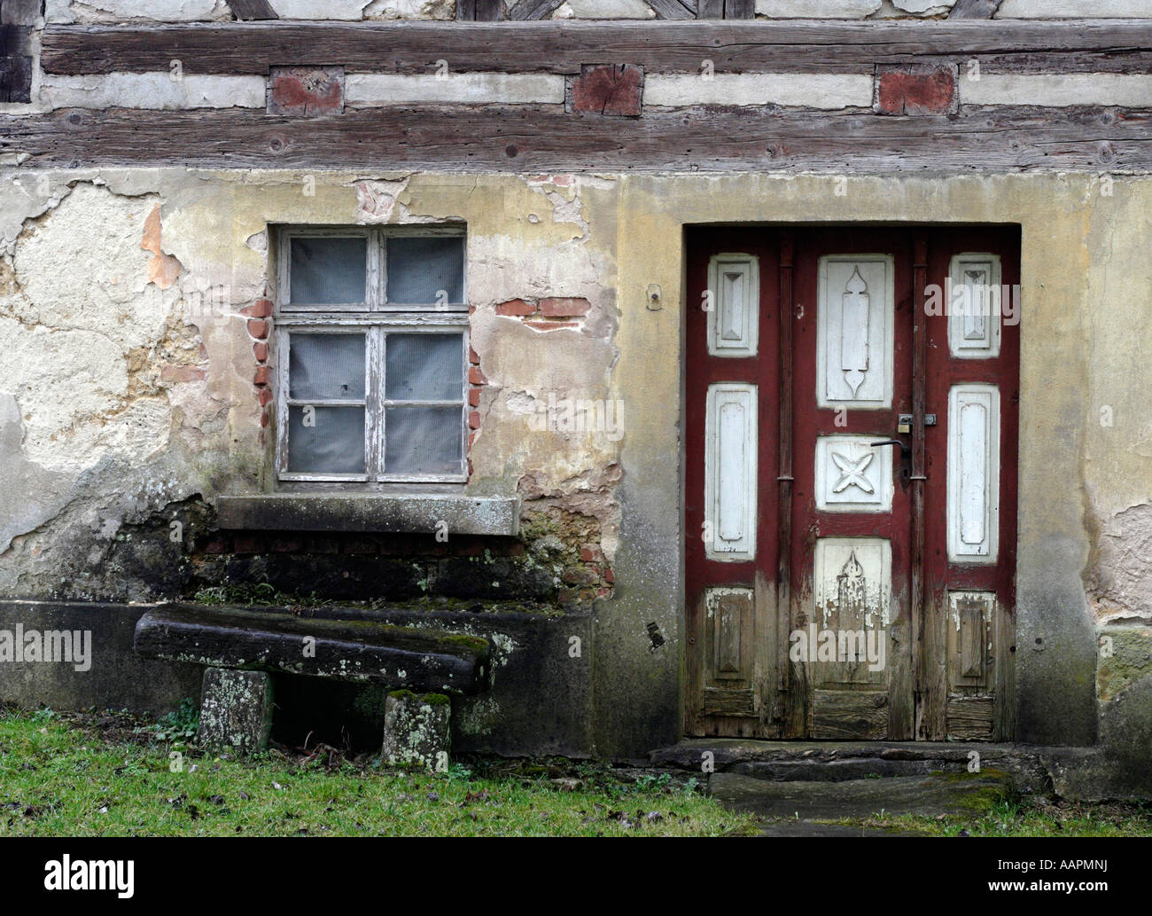 Desolate framework house with bench Stock Photo