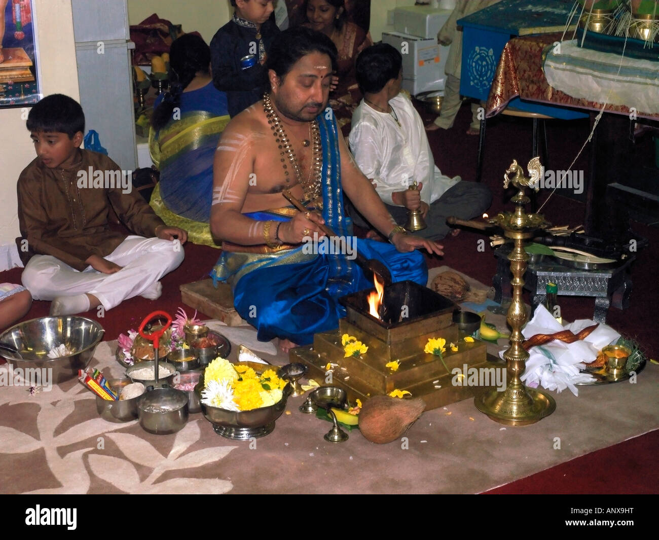 B0078P 0047 Murugan Temple New Malden Surrey England Priest During Ceremony With Sacred Fire Stock Photo