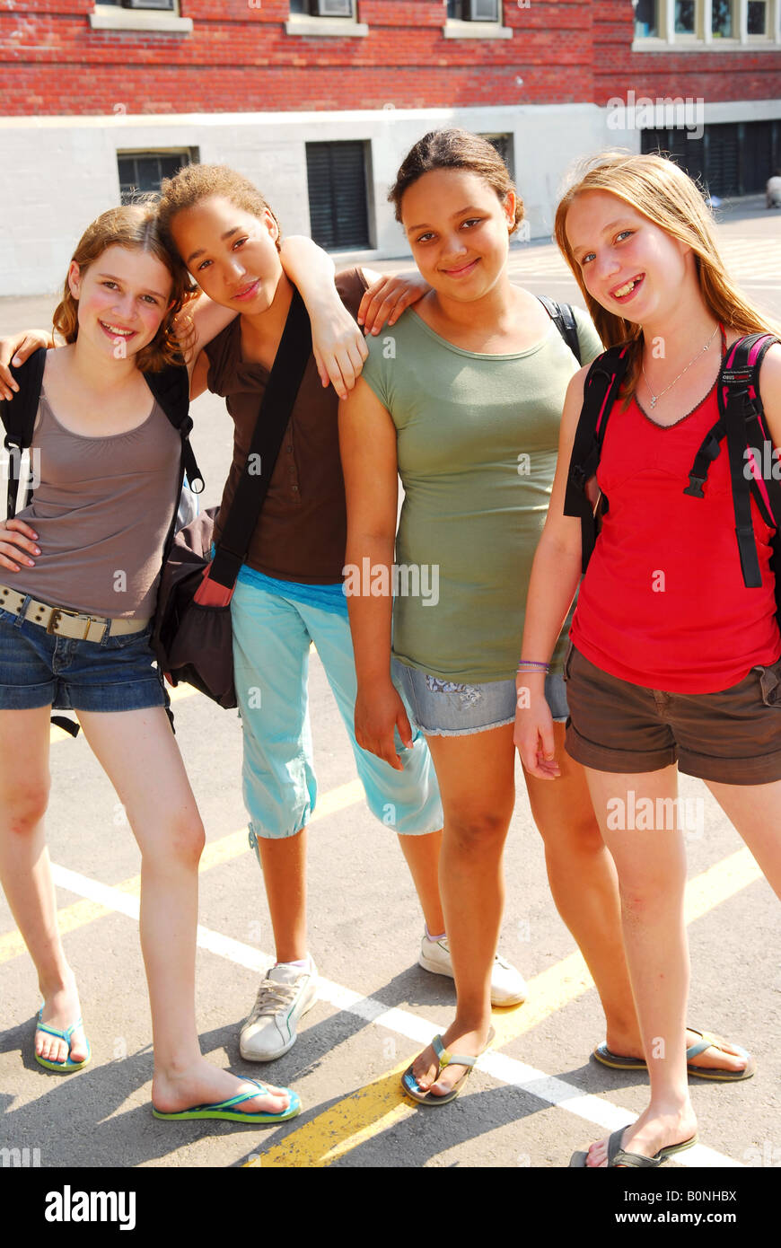 Portrait of a group of four young girls near school building Stock Photo