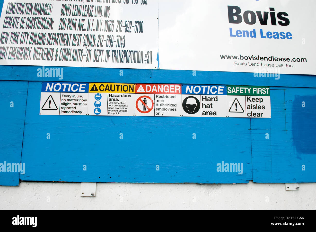 Various safety reminder signs at a construction site in New York Stock Photo