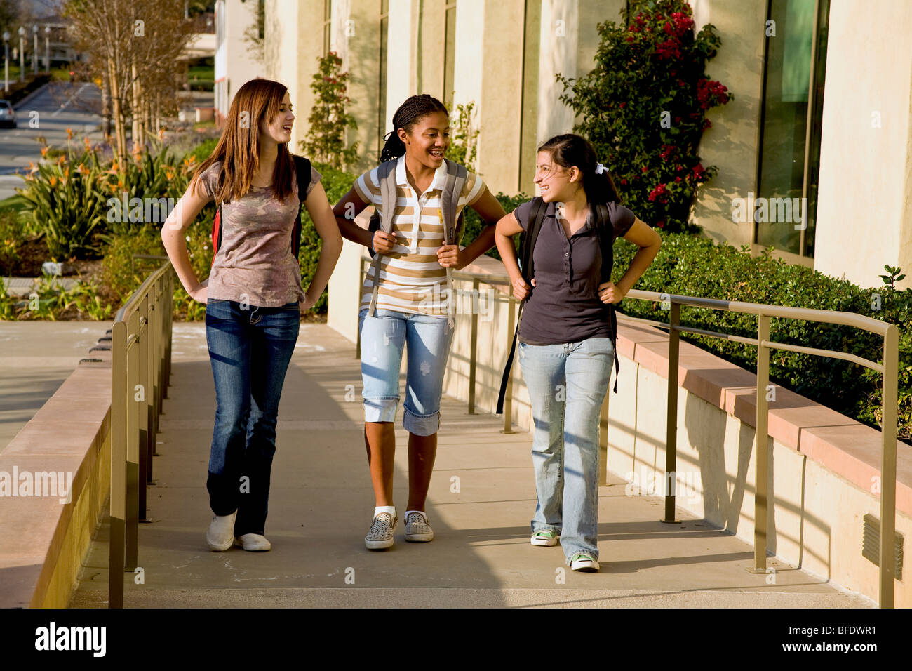 Diverse group of teenage girls Hang hanging out laughing and talking walking sidewalk California MR ©Myrleen Pearson Stock Photo