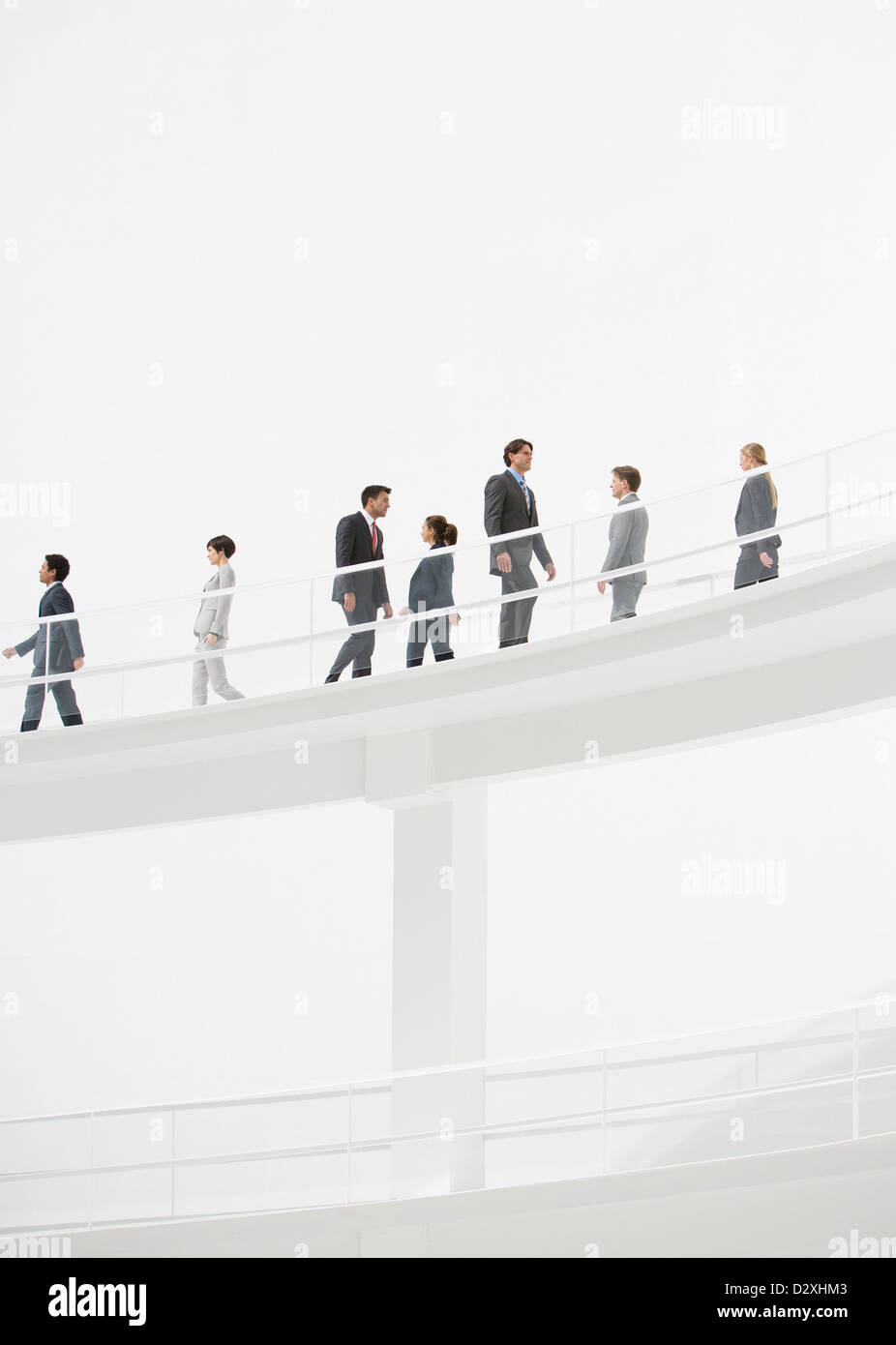 Business people walking along elevated walkway Stock Photo