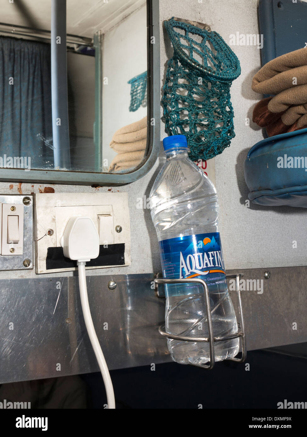 India, Rail Travel, 2nd class 2 tier air conditioned 2A carriage interior, bottle of Aquafina water in holder Stock Photo