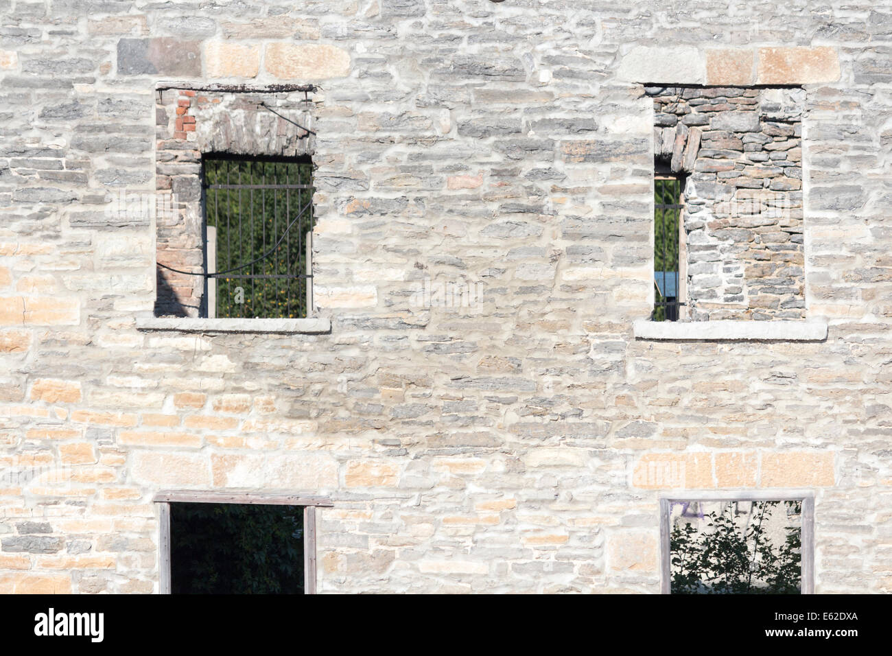 Old crumbling dilapidated mill wall face Stock Photo