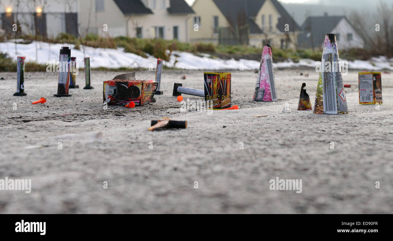 ILLUSTRATION - Used pyrotechnic devices stand on a street in Ennepetal, Germany, 01 January 2015. Photo: Caroline Seidel/dpa Stock Photo