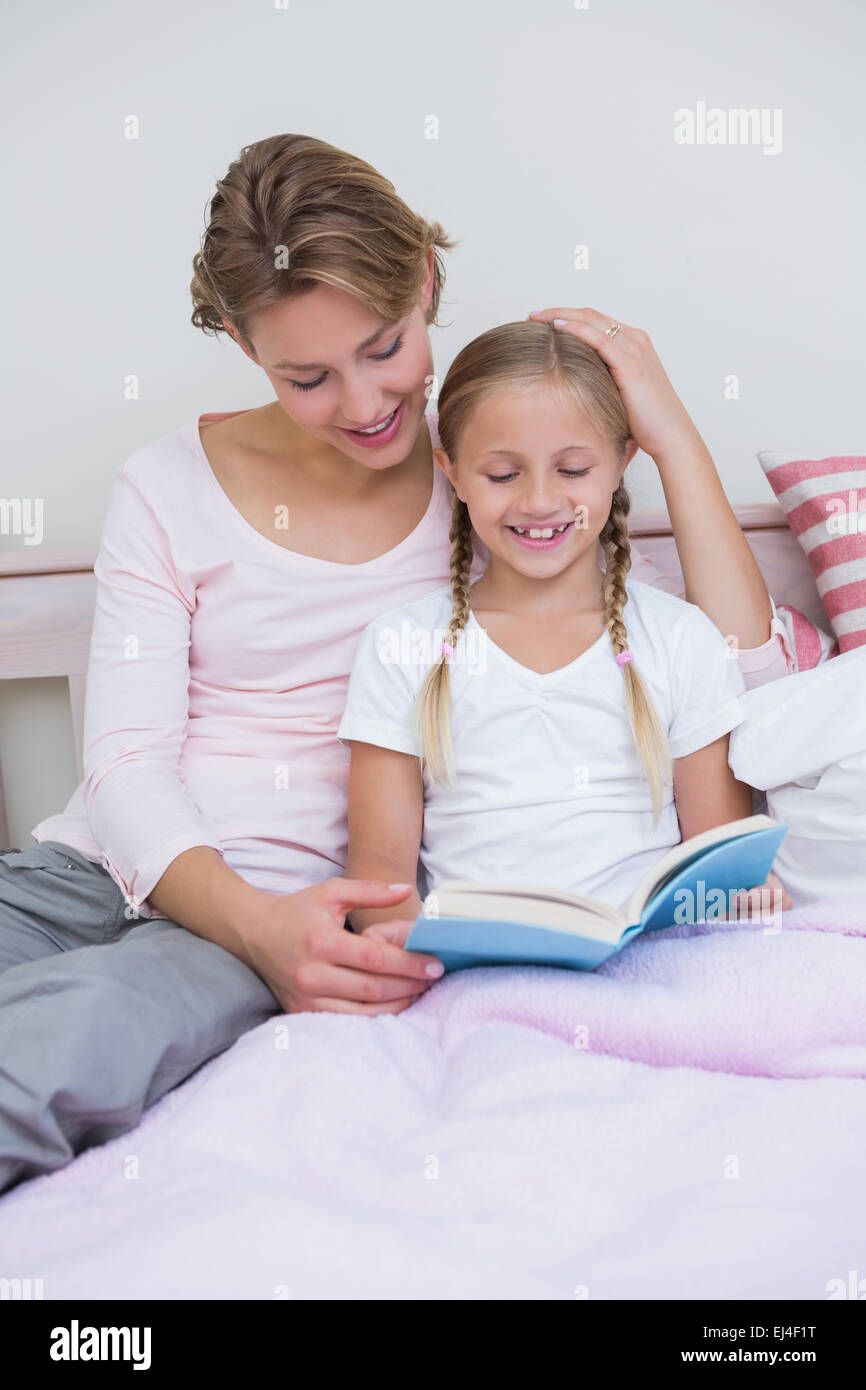 Mother with her daughter at bedtime Stock Photo