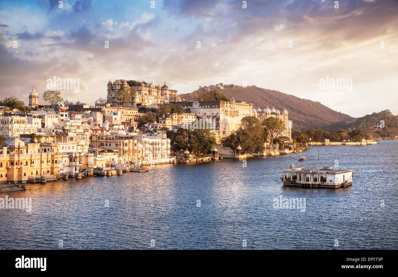 Lake Pichola with City Palace view at cloudy sunset sky in Udaipur, Rajasthan, India Stock Photo