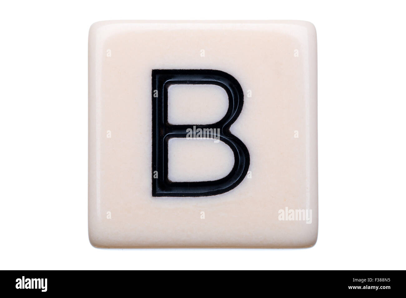 A macro shot of a game tile with the letter B on it on a white background. Stock Photo