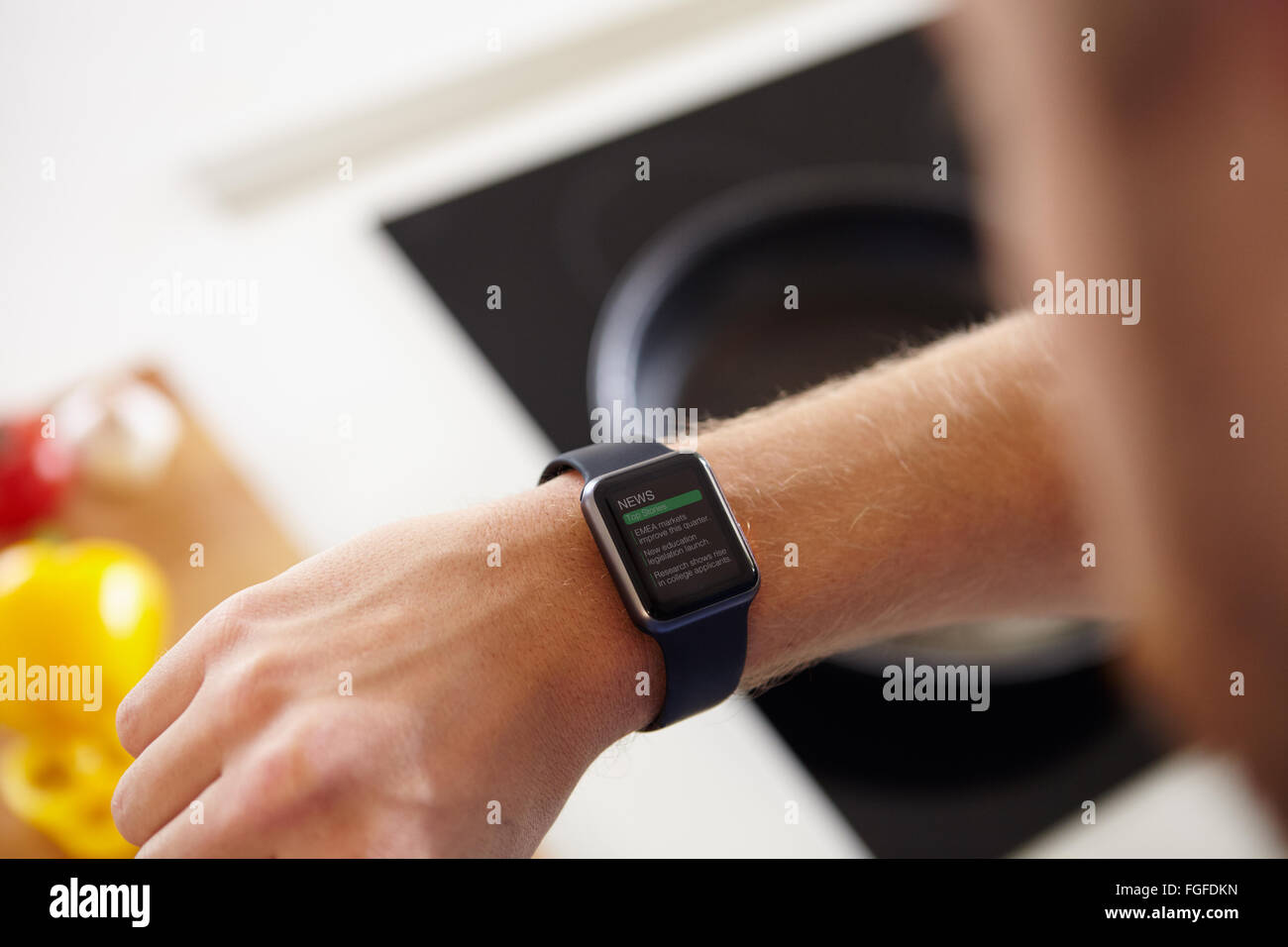 Man Looking At News Application Software On Smart Watch Stock Photo