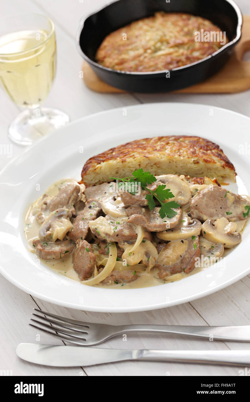 Zurich style veal stew and rosti potato, Swiss cuisine Stock Photo