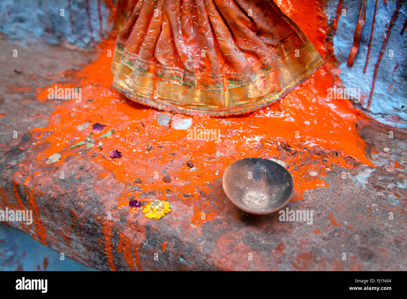 Close up on red colored powders miwed with water for puja on statue in Varanasi , India Stock Photo