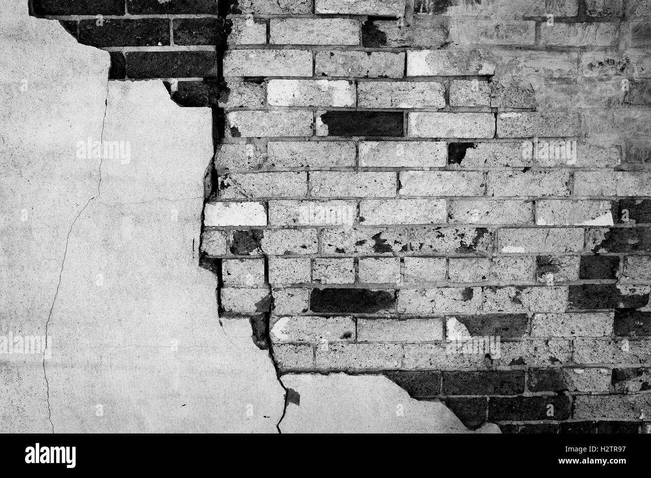 Detail of Wall Stucco plaster falling apart old crumbling bricks Stock Photo