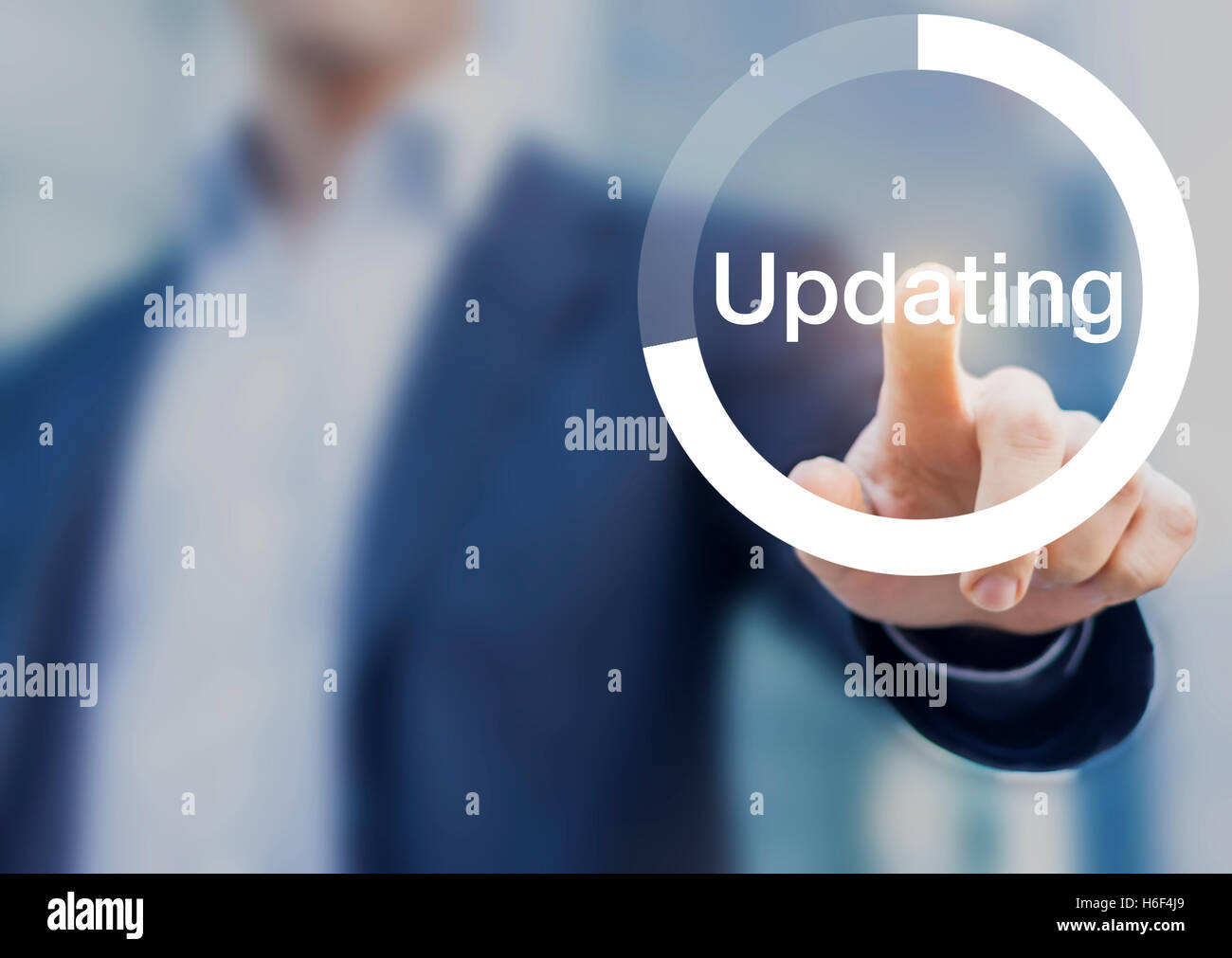 Concept about software updating with a person touching a progress button on a computer interface Stock Photo