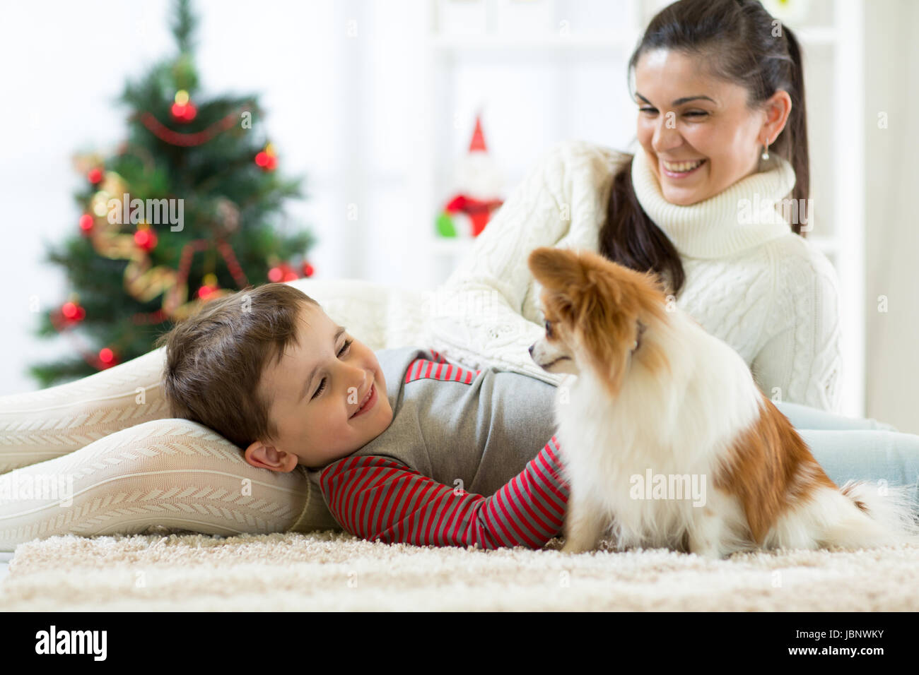 Family with dog at christmas tree Stock Photo