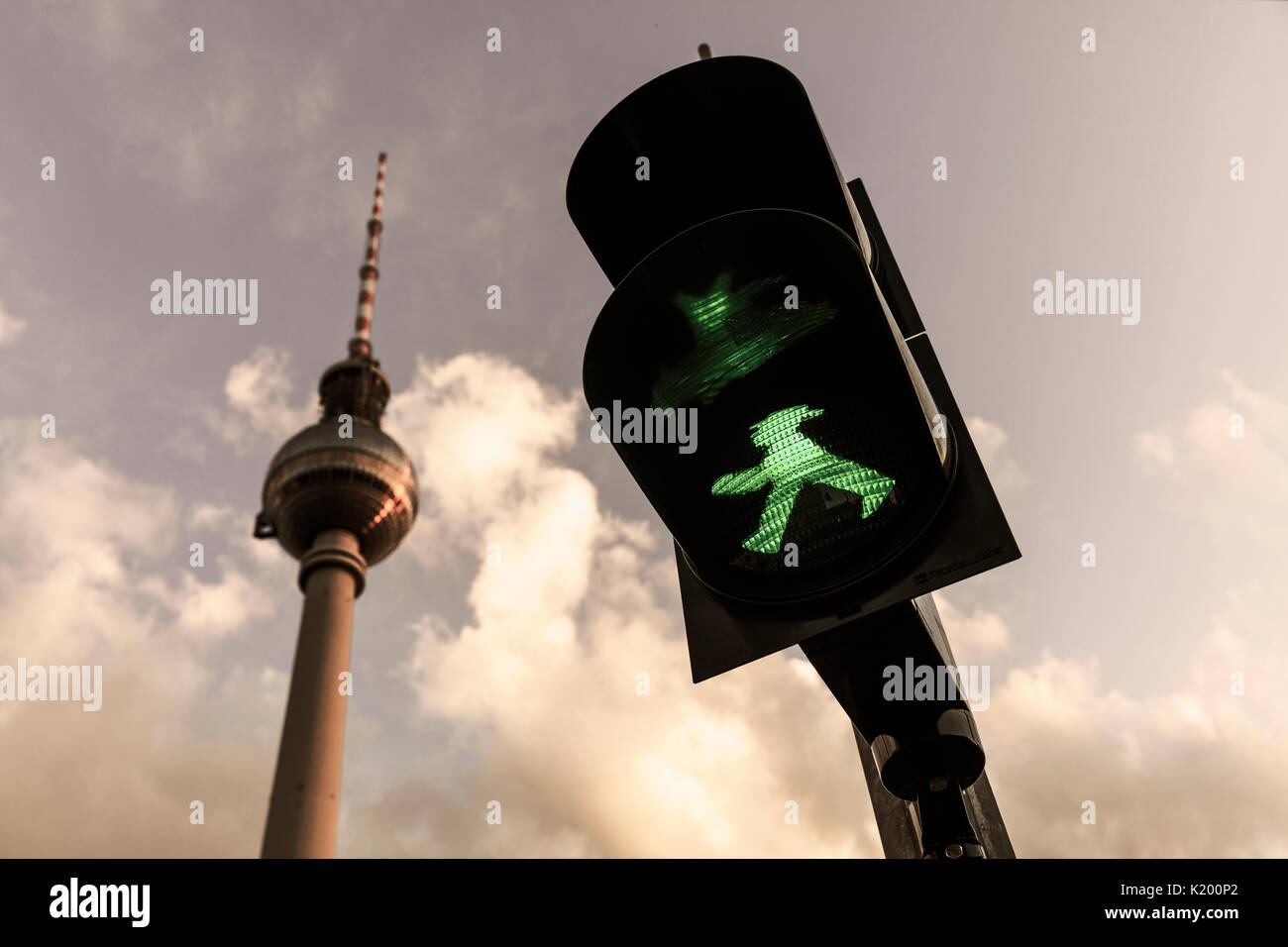 Green Ampelmann on Berlin Traffic Light with Berlin TV Tower in background (Berliner Fernsehturm) August 14th 2017, Berlin, Germany Stock Photo