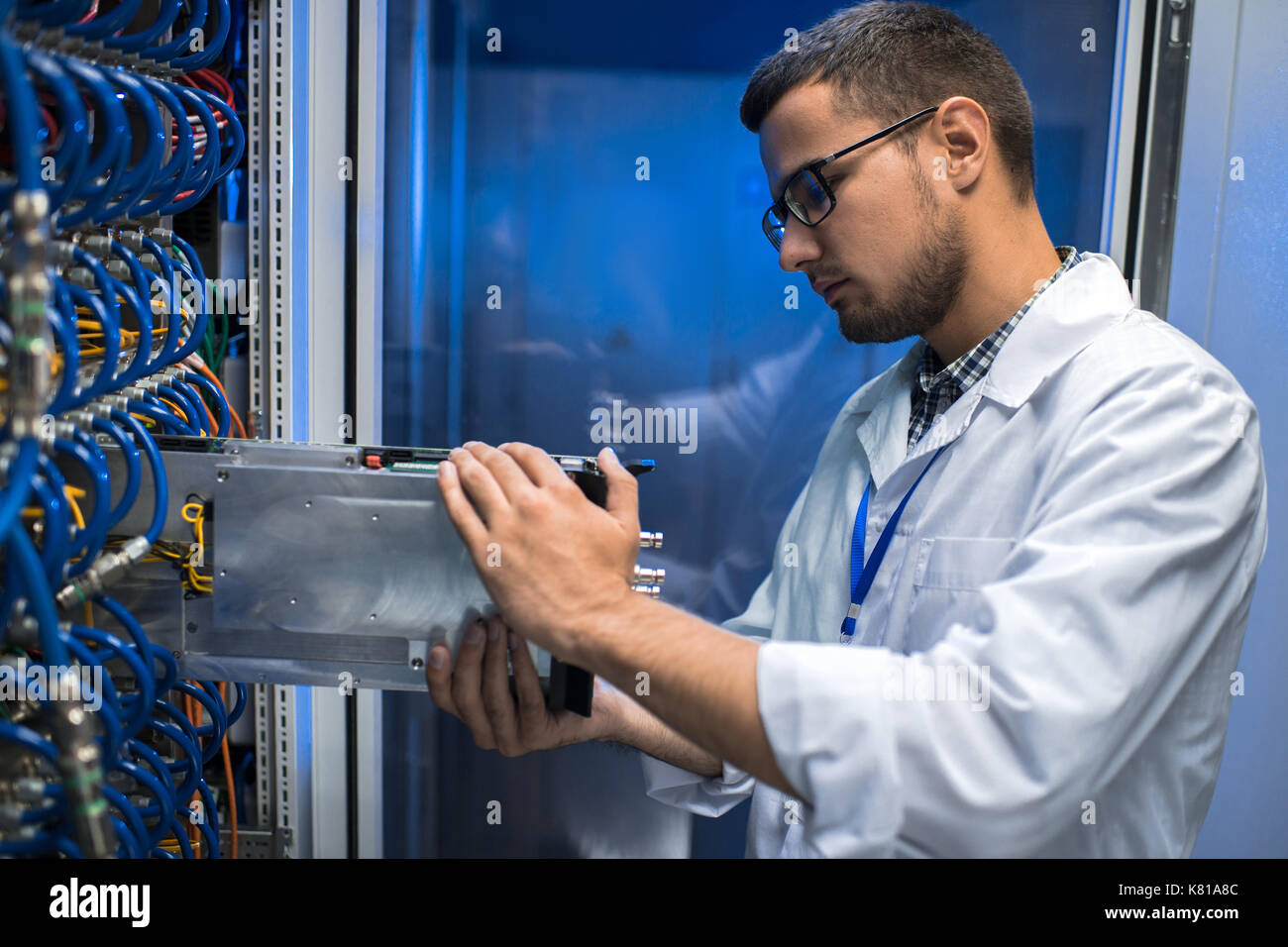 IT Scientist Working with Supercomputer Stock Photo