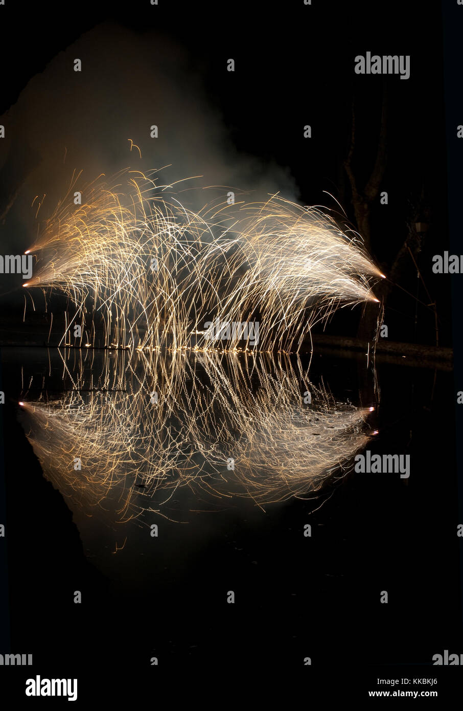 White fireworks forming semicircle reflection in an old millrace pond in Provence France Stock Photo