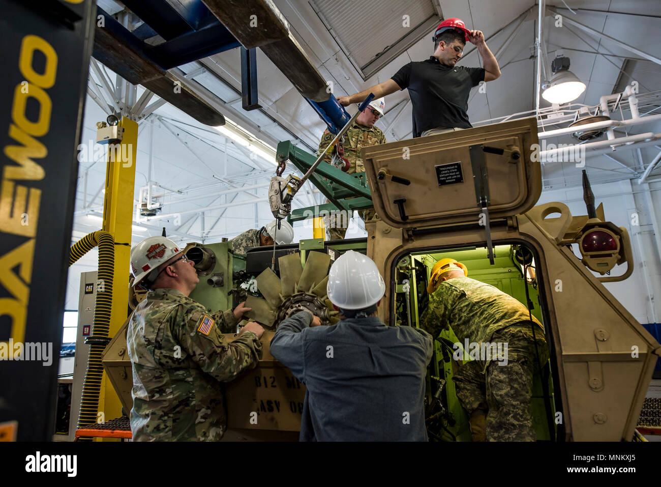 U.S. Army Reserve mechanics from across the 200th Military Police Command work on an M117 Armored Security Vehicle (ASV) during a maintenance course hosted by the 99th Readiness Division in Schenectady, New York, March 14, 2018. This is the first maintenance course in the U.S. Army Reserve designed specifically for the ASV, which has hydraulic components and maintenance procedures that are unlike most other Army vehicles. The ASV is designed to resist the impact of roadside bombs while operating in urban environments. Its mounting systems allow the ASV to hold an M2 .50-caliber machine gun, a  Stock Photo