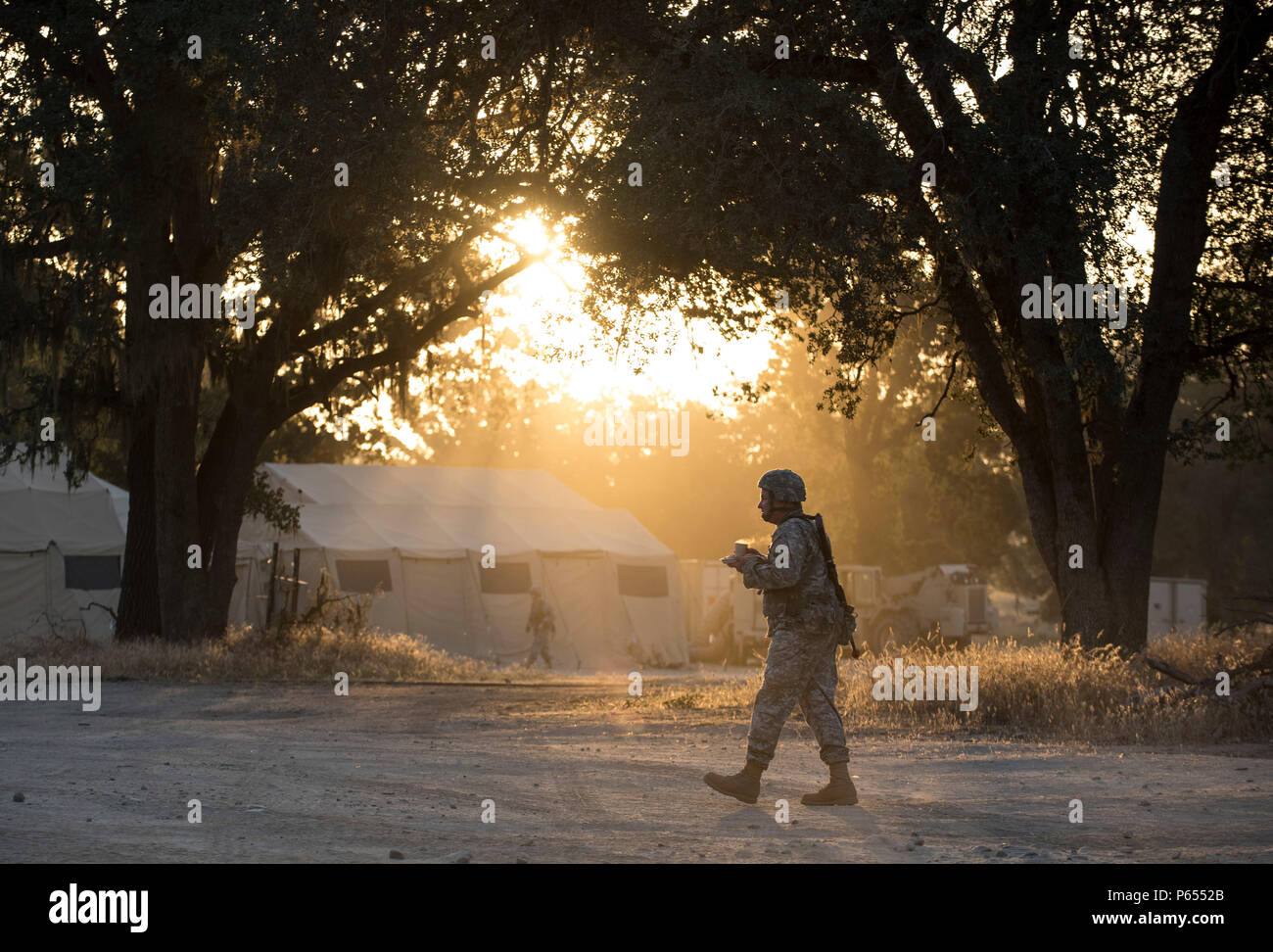 A U.S. Army Reserve Soldier carries his breakfast tray and hot beverage during a morning in the field at Forward Operating Base Schoonover at Fort Hunter-Liggett, California, May 3, 2016. Approximately 80 units from across the U.S. Army Reserve, Army National Guard and active Army participated in the 84th Training Command's second Warrior Exercise this year hosted by the 91st Training Division at Fort Hunter-Liggett, California. (U.S. Army photo by Master Sgt. Michel Sauret) Stock Photo