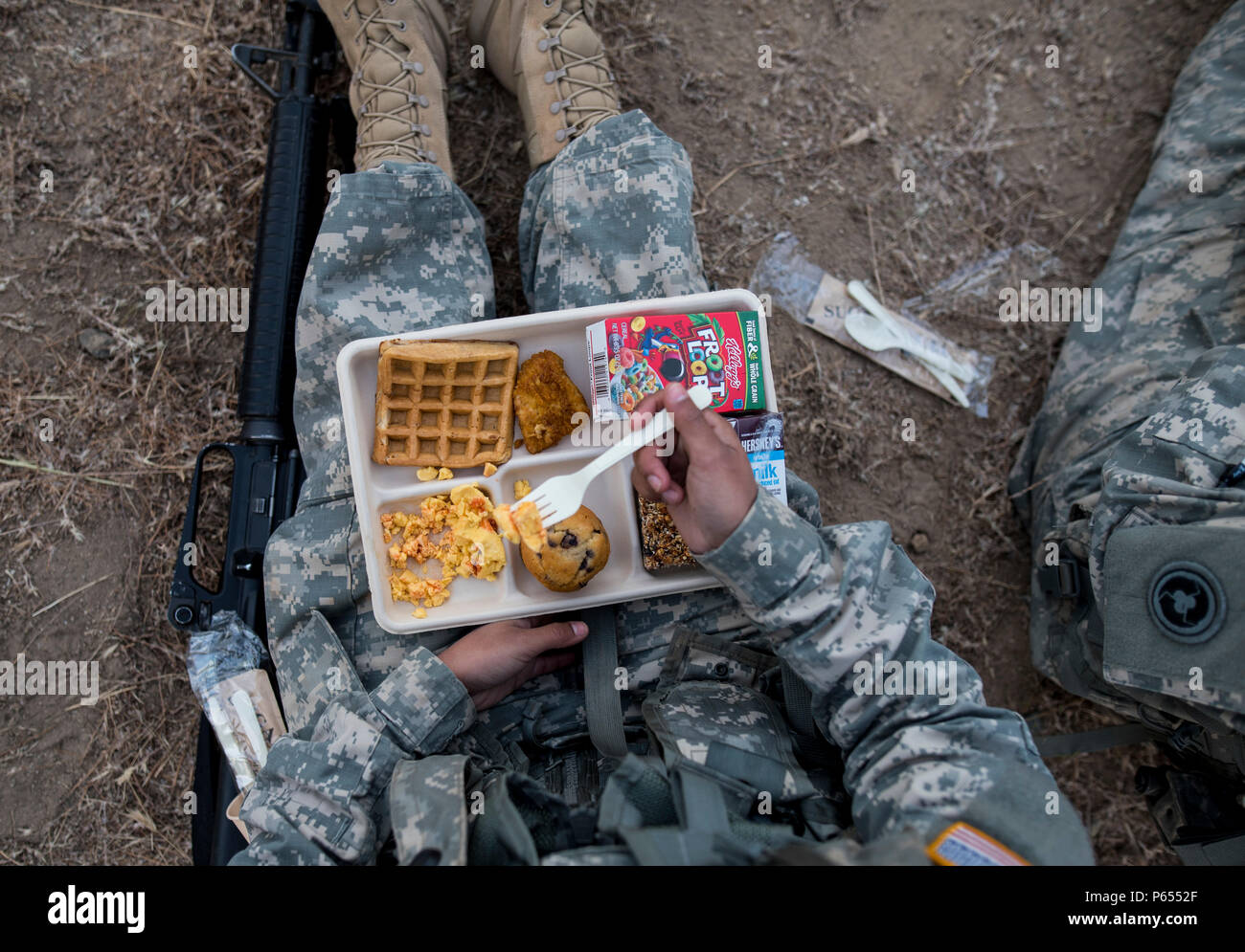 A U.S. Army Reserve Soldier eats breakfast in the field at Forward Operating Base Schoonover at Fort Hunter-Liggett, California, May 3. Approximately 80 units from across the U.S. Army Reserve, Army National Guard and active Army are participating in the 84th Training Command's second Warrior Exercise this year, WAREX 91-16-02, hosted by the 91st Training Division at Fort Hunter-Liggett, California. (U.S. Army photo by Master Sgt. Michel Sauret) Stock Photo