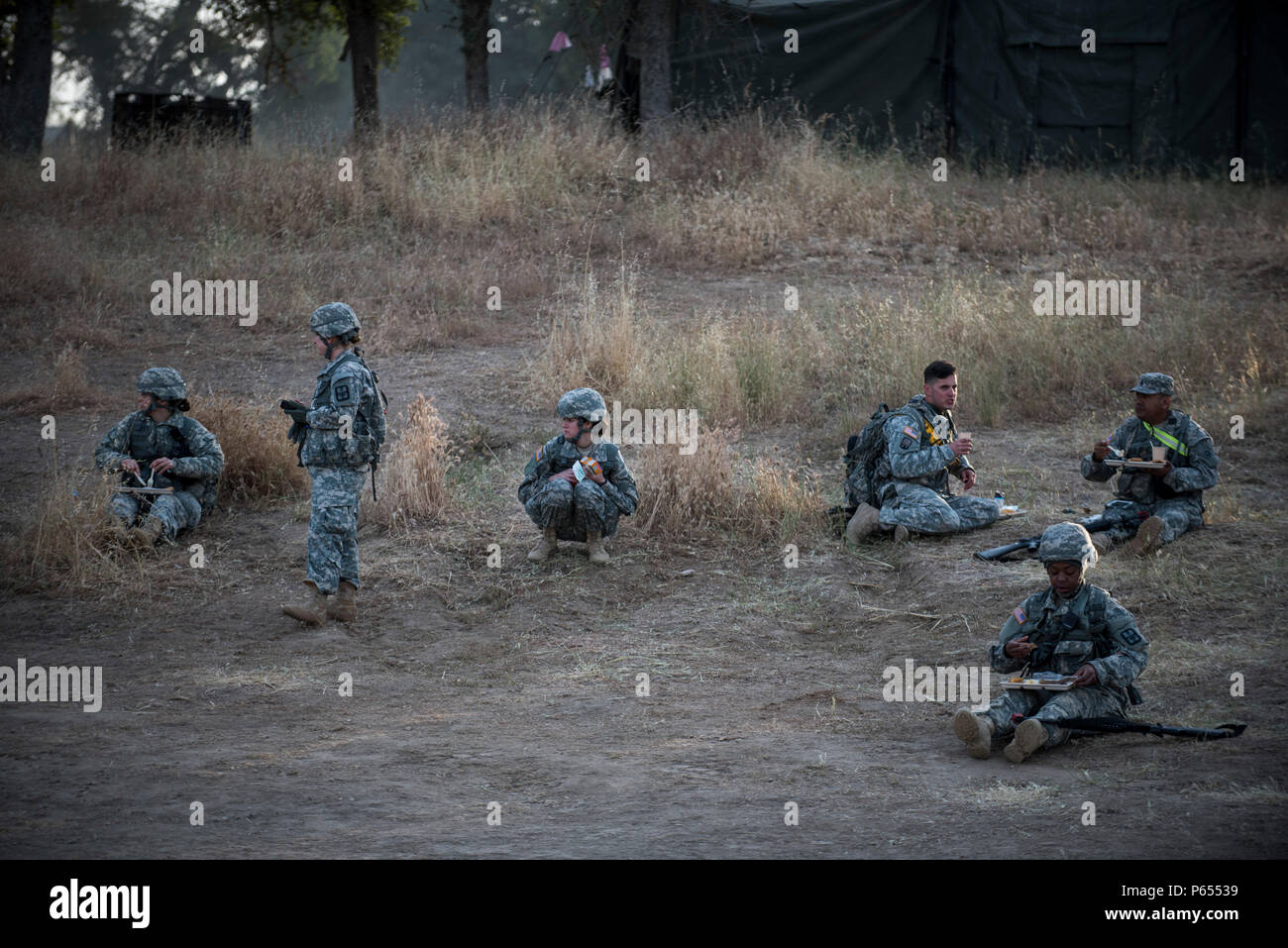 U.S. Army Reserve Soldiers scatter across the ground to eat breakfast in the field at Forward Operating Base Schoonover at Fort Hunter-Liggett, California, May 3. Approximately 80 units from across the U.S. Army Reserve, Army National Guard and active Army are participating in the 84th Training Command's second Warrior Exercise this year, WAREX 91-16-02, hosted by the 91st Training Division at Fort Hunter-Liggett, California. (U.S. Army photo by Master Sgt. Michel Sauret) Stock Photo