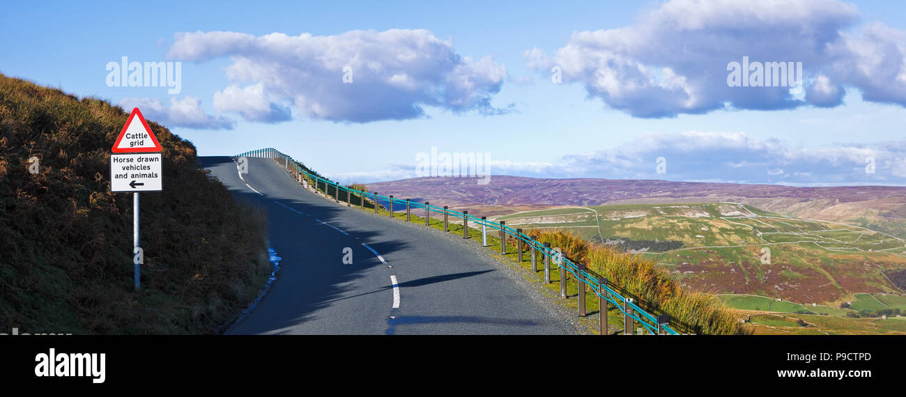 Elevated country road with a warning sign for a cattle grid ahead in the Yorkshire Dales National Park, England, UK Stock Photo