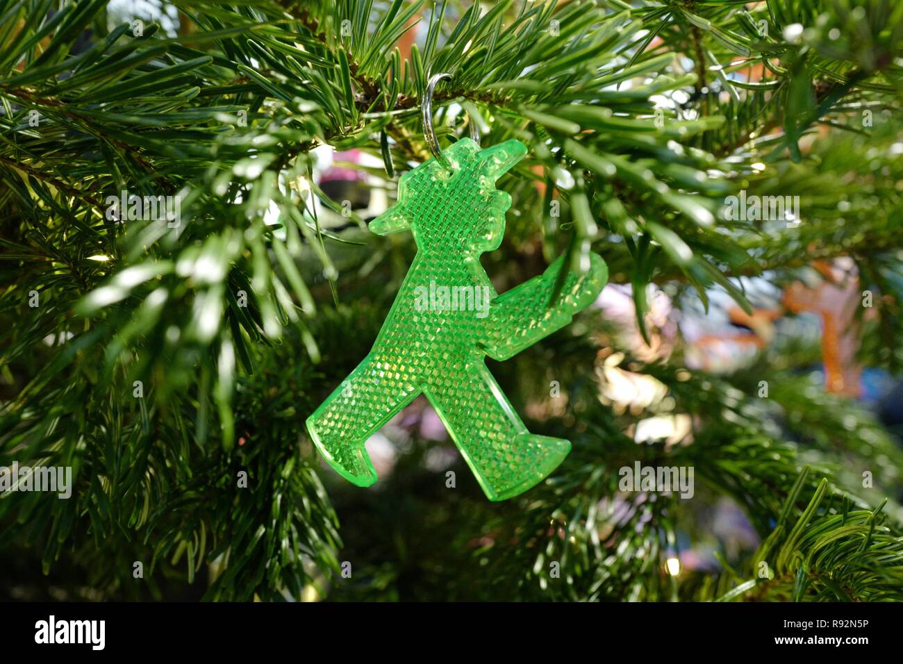 19 December 2018, Berlin: A traffic light man hangs from a Christmas tree in the 'Little Big City Berlin'. All objects hanging from the tree were originally invented in Berlin. Photo: Jörg Carstensen/dpa Stock Photo