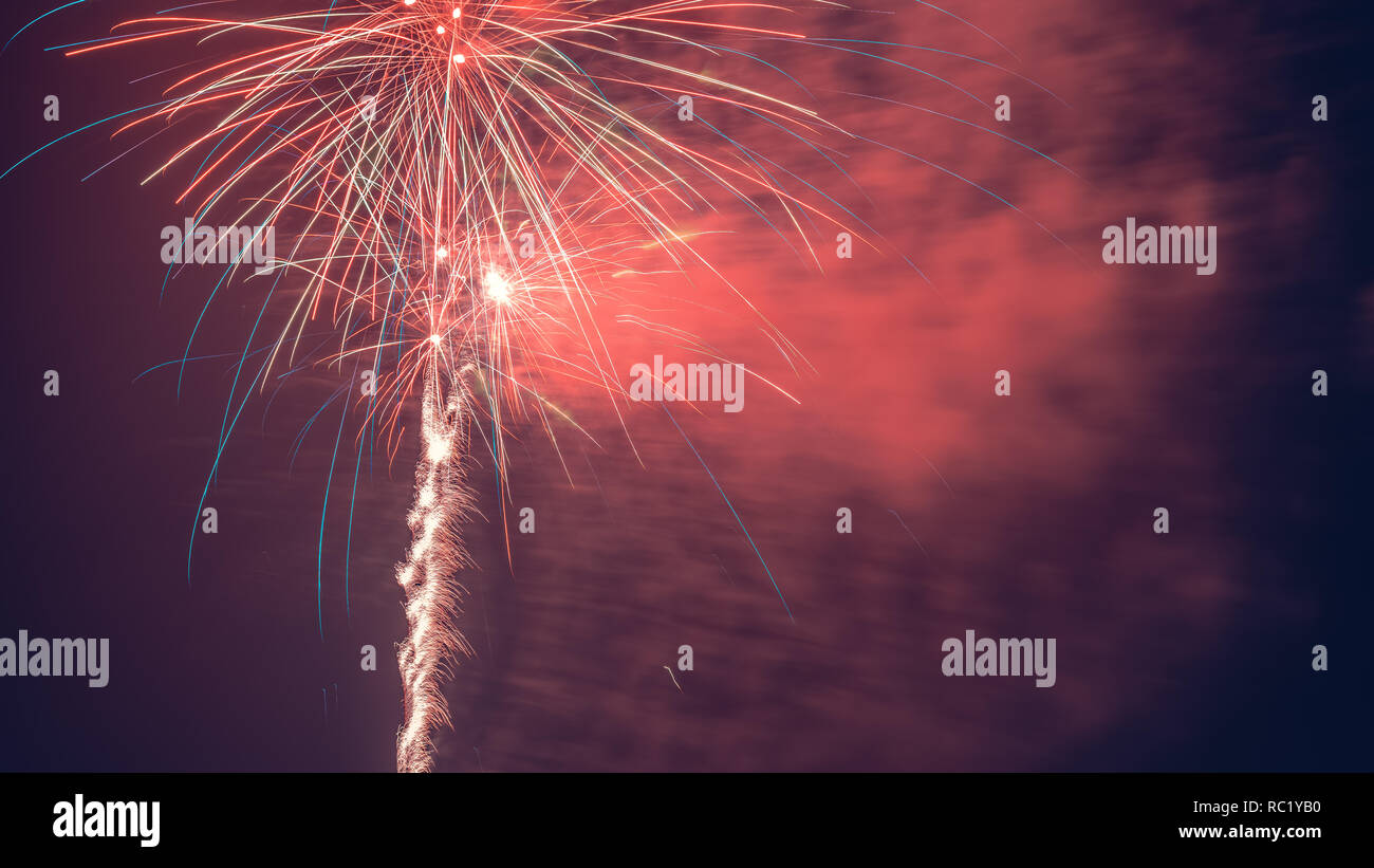 Fireworks are a class of low explosive pyrotechnic devices used for aesthetic and entertainment purposes. Stock Photo