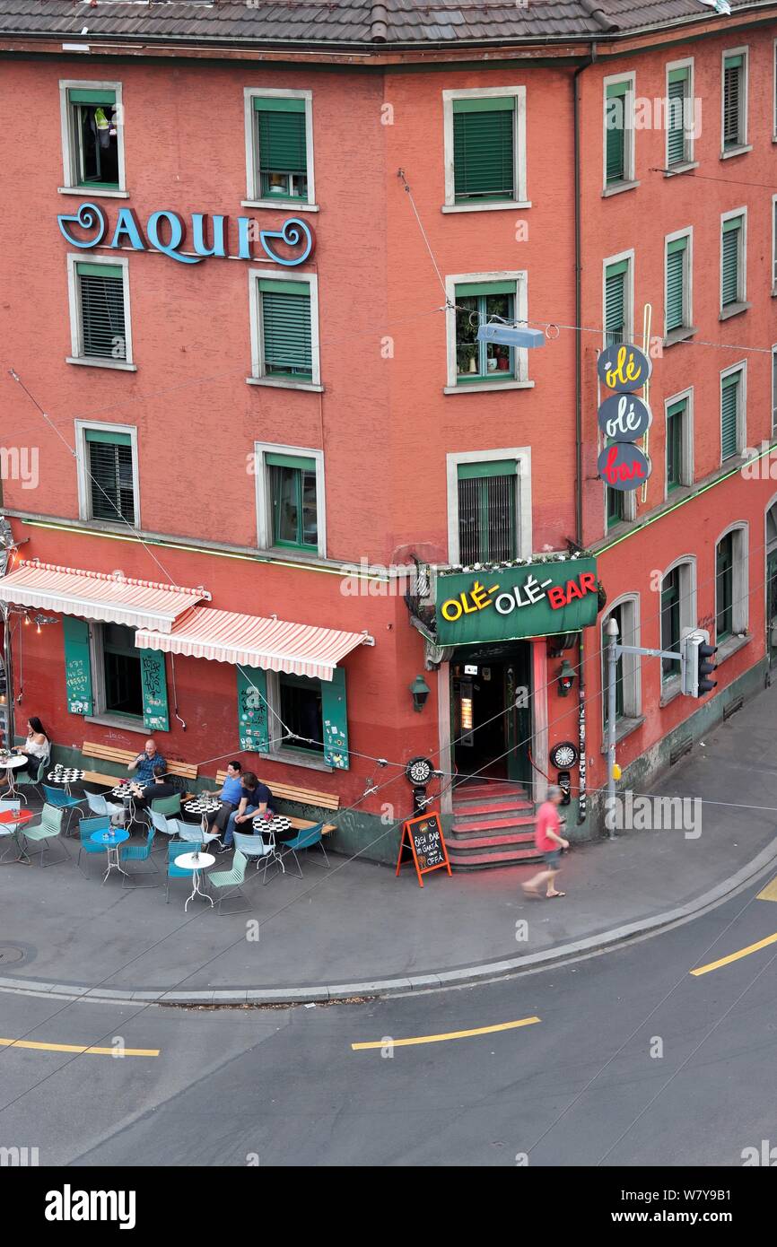 ZURICH, SWITZERLAND - july 20, 2019: People enjoying drinks in front of ole ole bar at langstrasse. Long exposure shot. Stock Photo