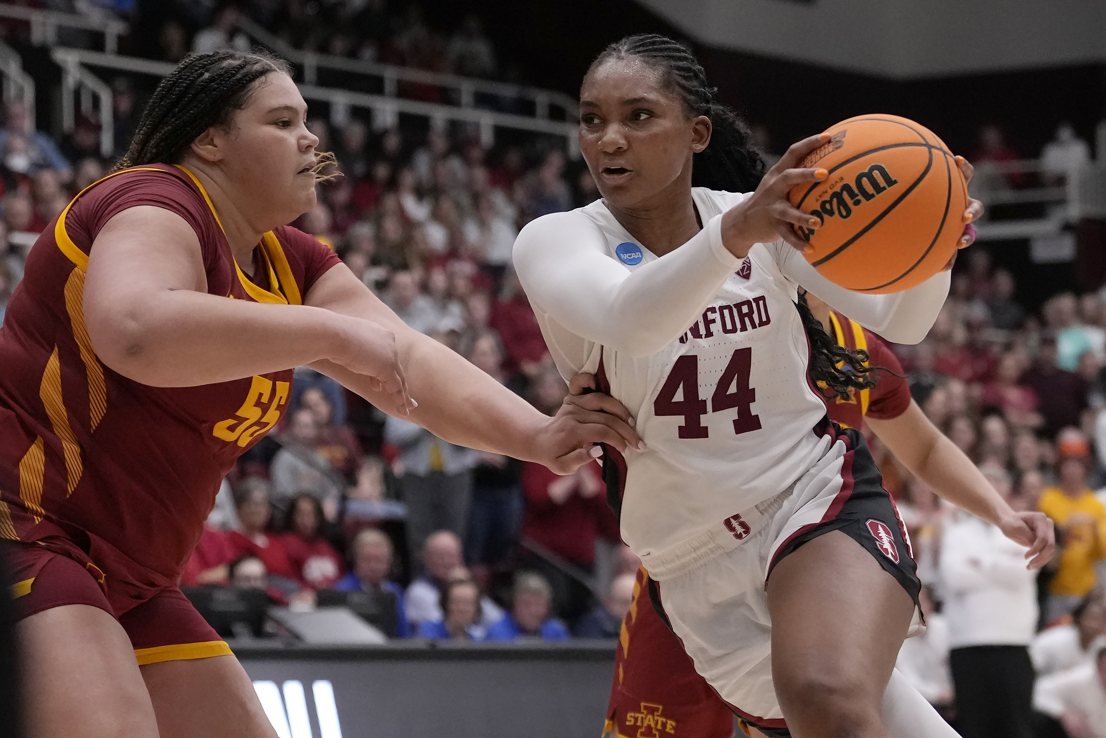 Stanford forward Kiki Iriafen, right, drives to the basket in front of Iowa State center Audi Crooks.