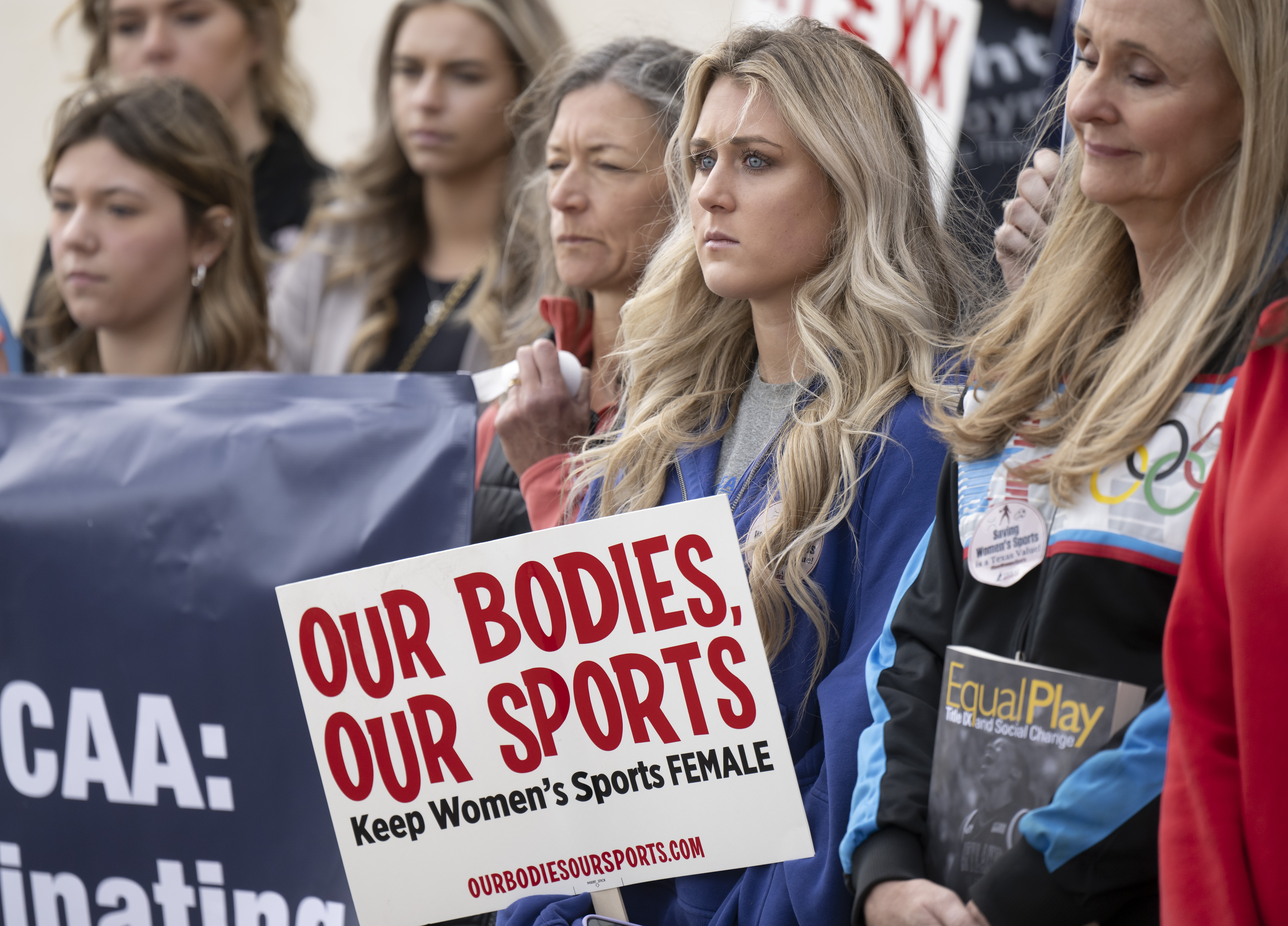 FILE - Former University of Kentucky swimmer Riley Gaines, second from right, stands during a rally.