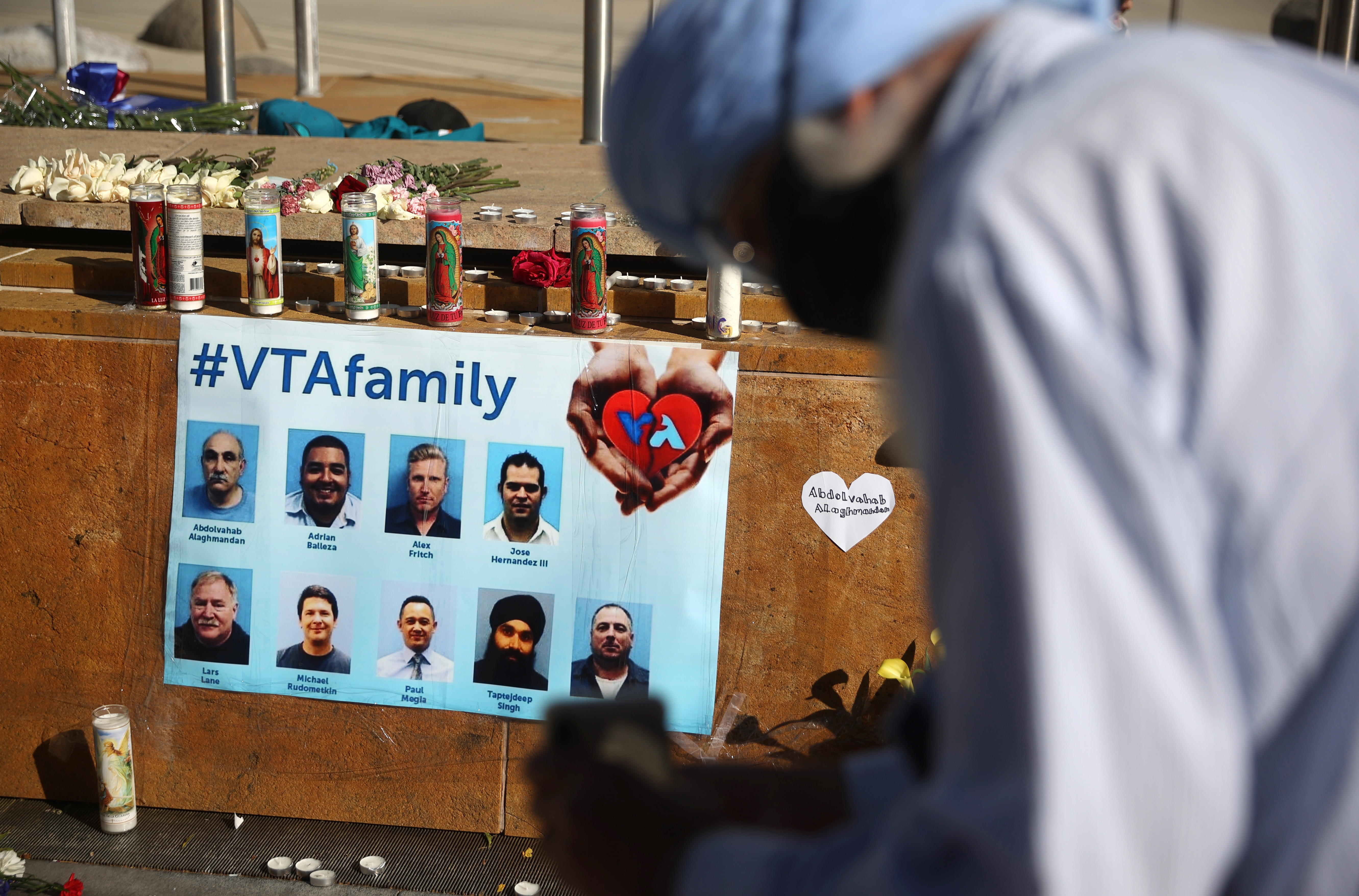 SAN JOSE, CALIFORNIA - MAY 27: A mourner pauses in front of a memorial for the nine victims of a shooting at the Santa Clara Valley Transportation Authority (VTA) light rail yard on May 27, 2021 in San Jose, California. Nine people were killed when a VTA employee opened fire at the VTA light rail yard during a shift change on Wednesday morning. (Photo by Justin Sullivan/Getty Images)