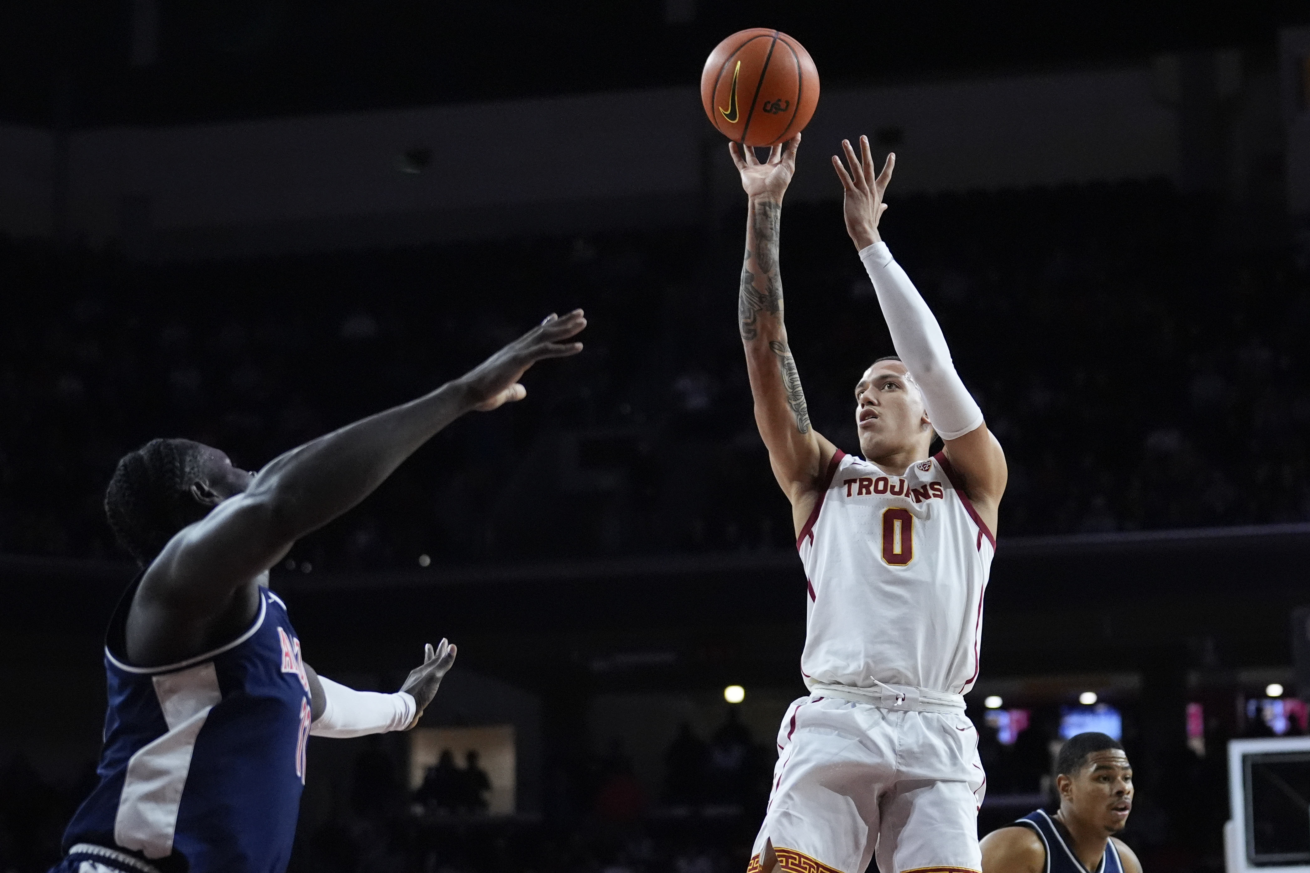 Southern California guard Kobe Johnson (0) shoots over Arizona center Oumar Ballo.