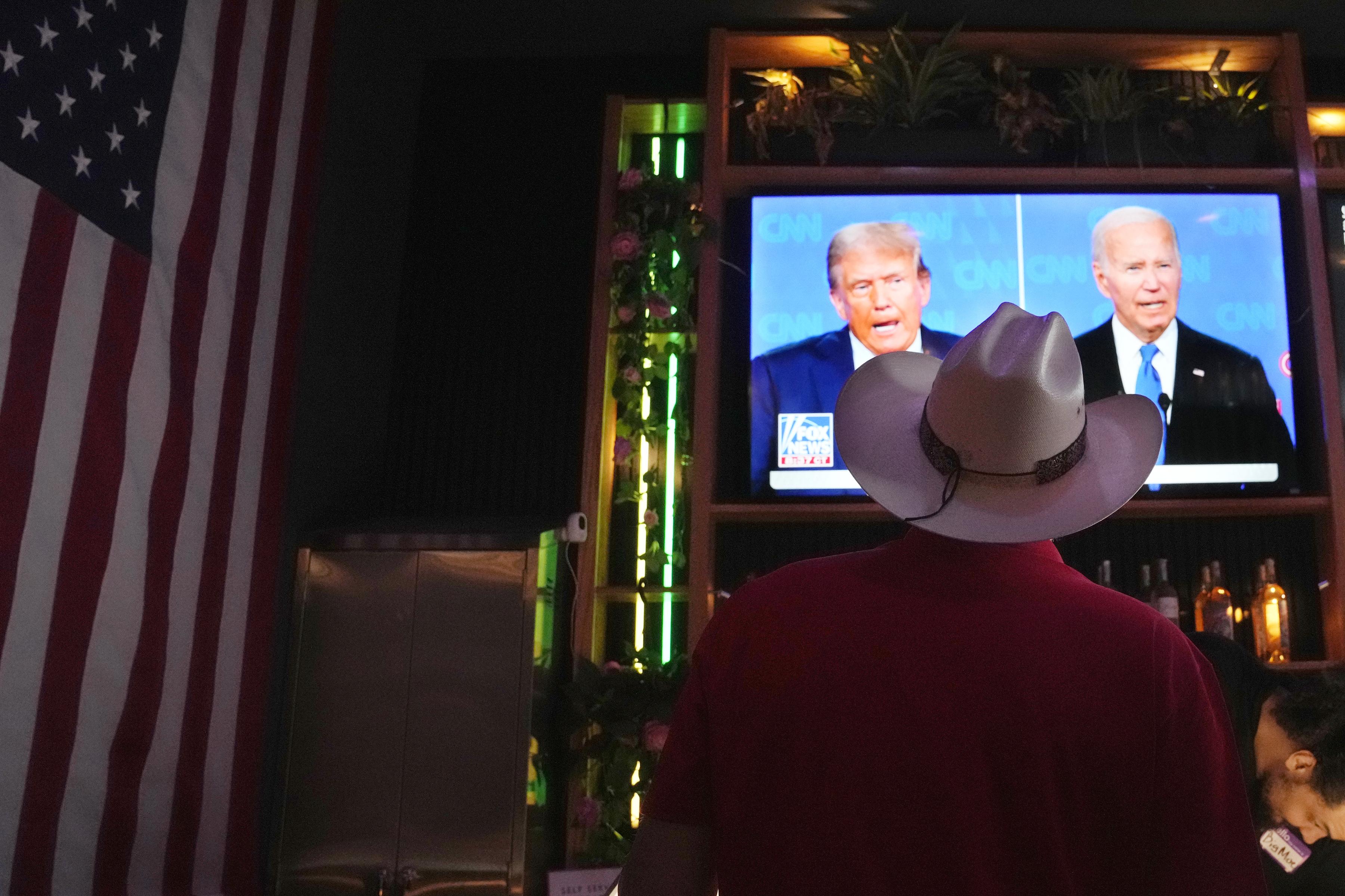 Roger Strassburg, of Scottsdale, Ariz., wears a cowboy hat as he watches the presidential debate between President Joe Biden and Republican presidential candidate former President Donald Trump at a debate watch party Thursday, June 27, 2024, in Scottsdale, Ariz. (AP Photo/Ross D. Franklin)