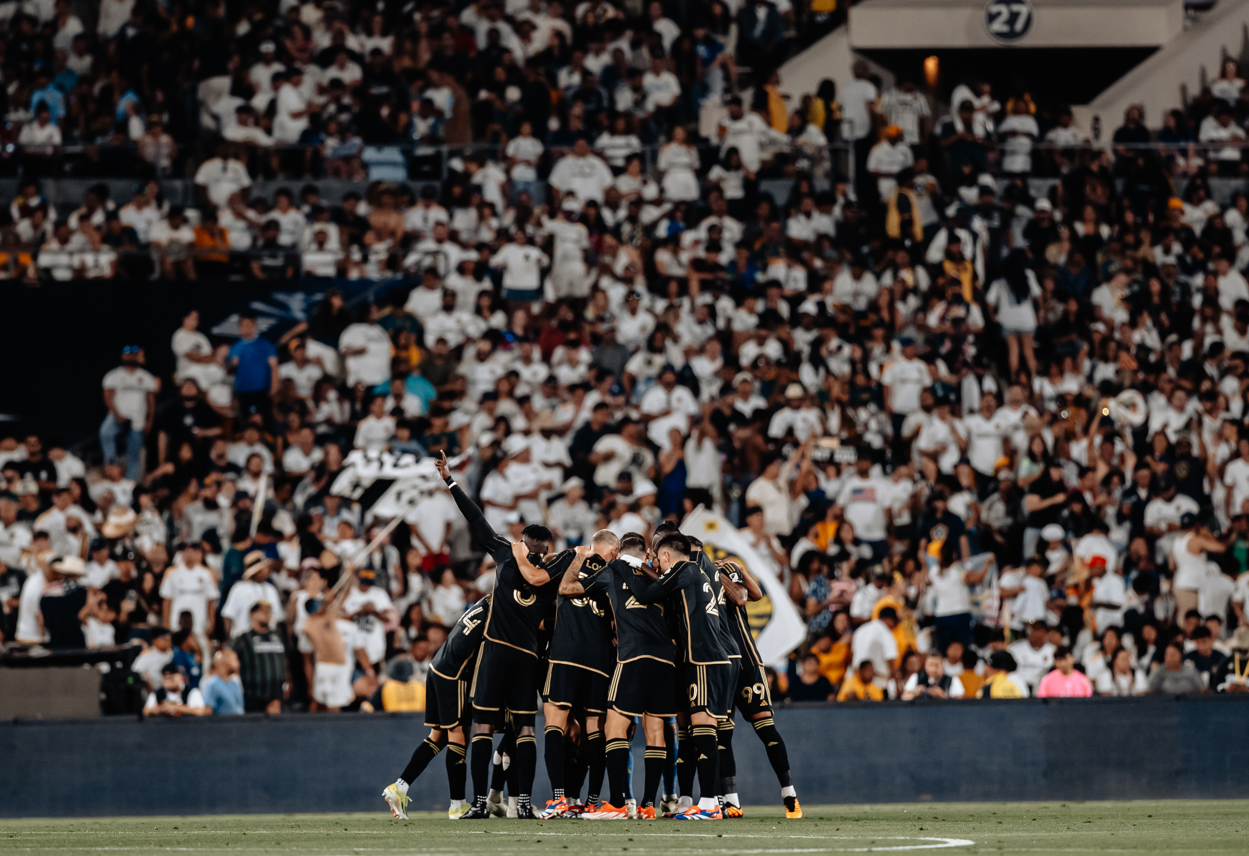 LAFC players huddle after securing a win over the Galaxy on Thursday, July 4, at the Rose Bowl in Pasadena.