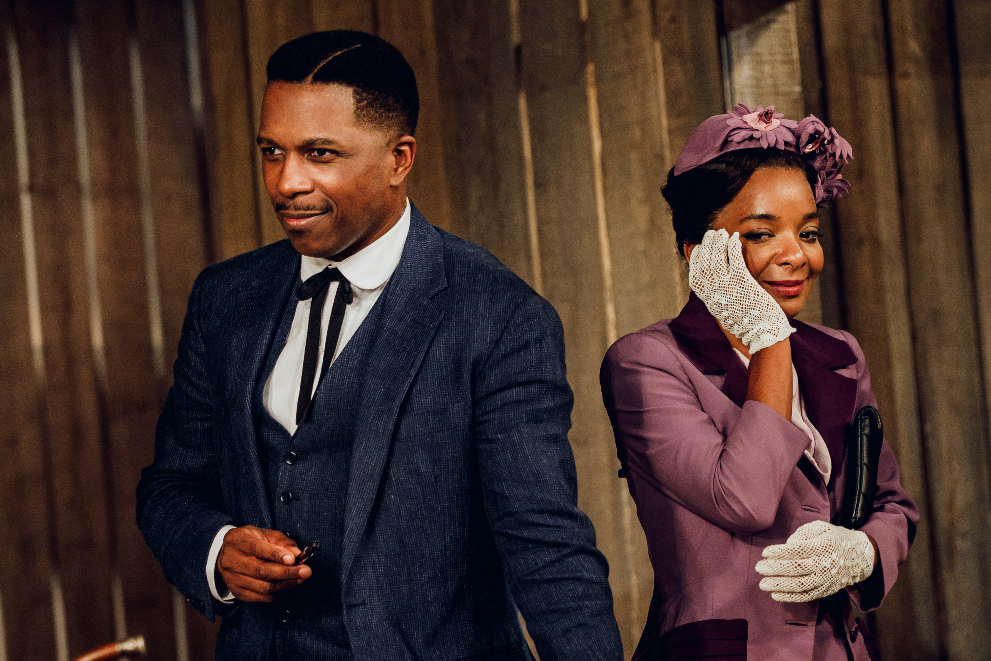 A man in a blue suit and a woman in a purple dress.