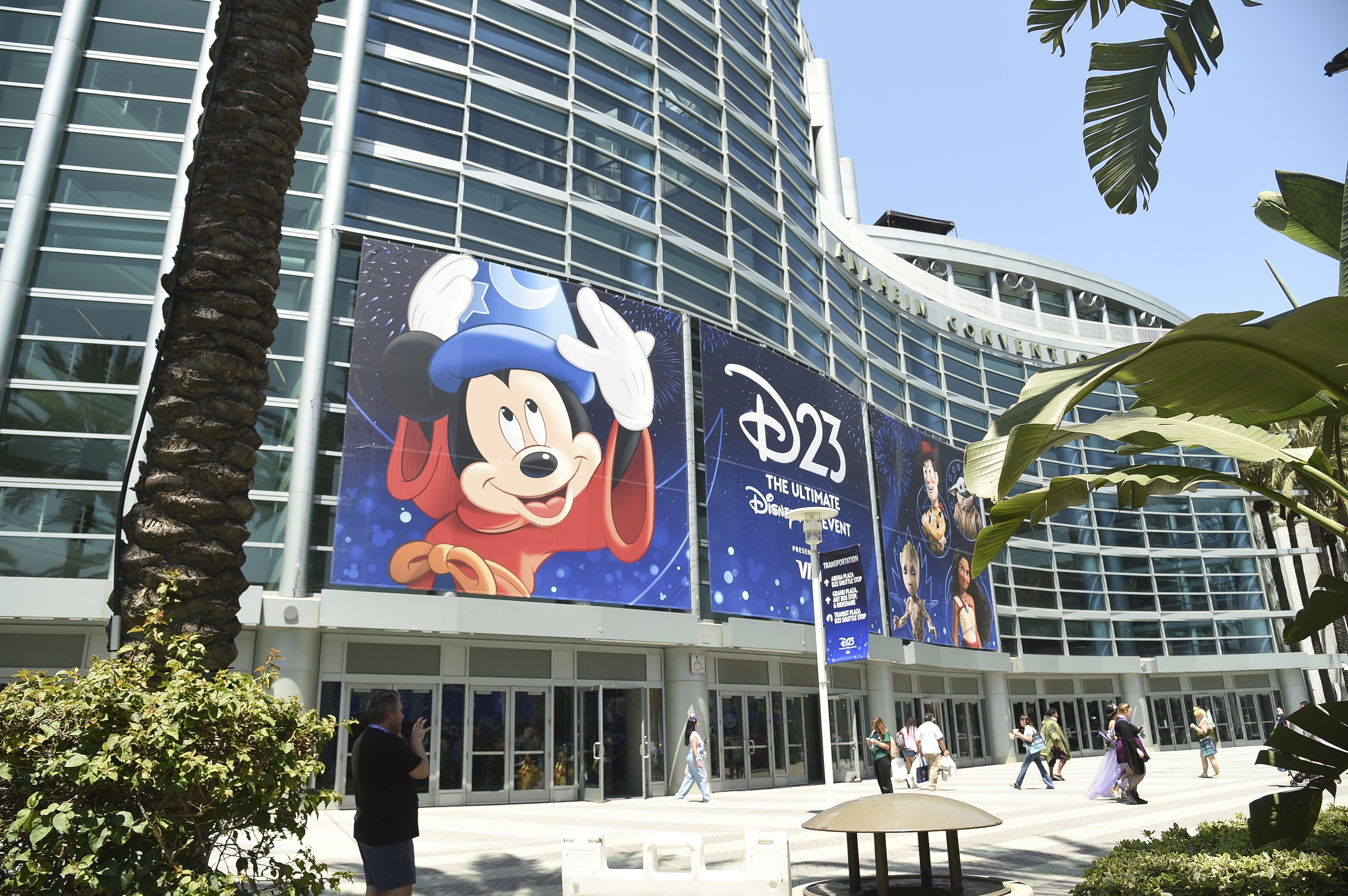 A massive poster advertising Disney's fan convention, D23, is displayed on the side of the Anaheim Convention Center.